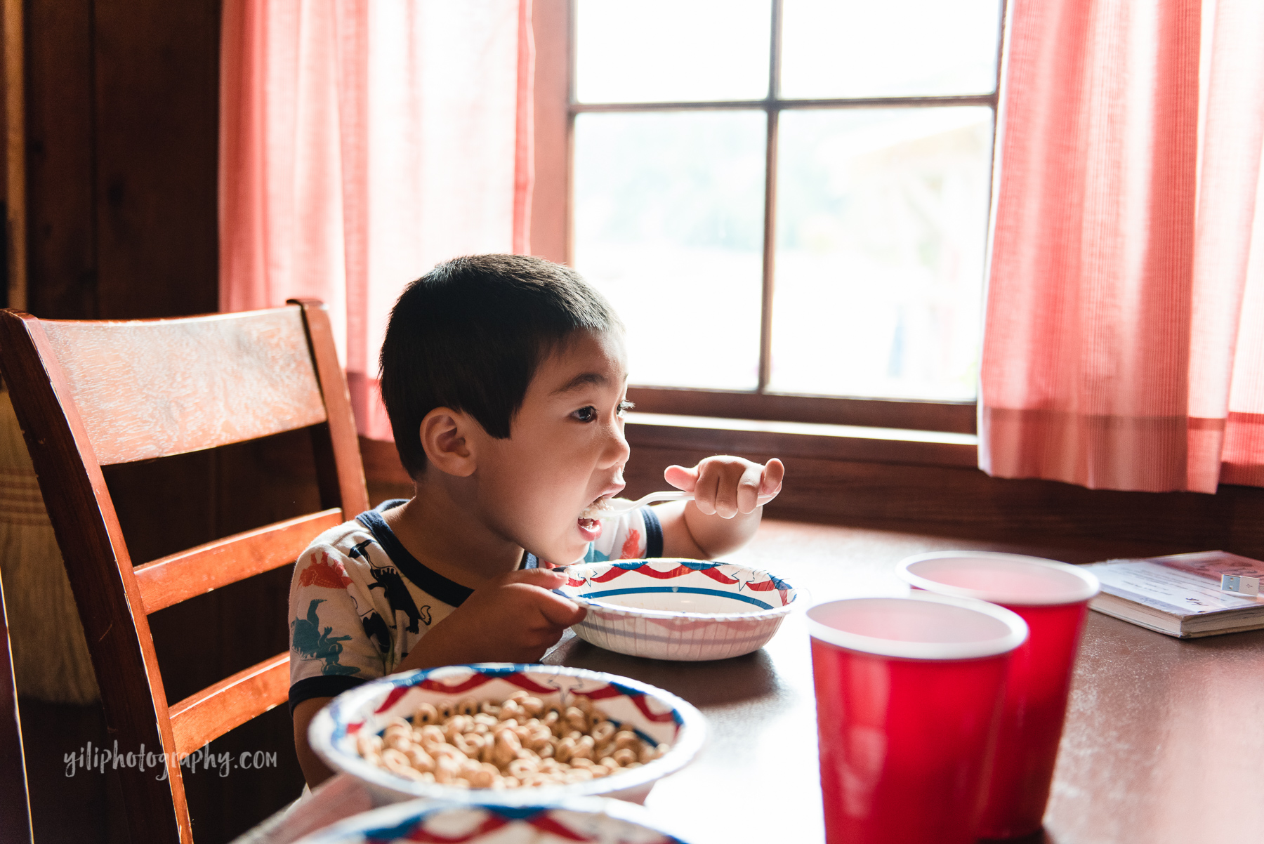 seattle boy eating breakfast inside cabin at cama beach state park