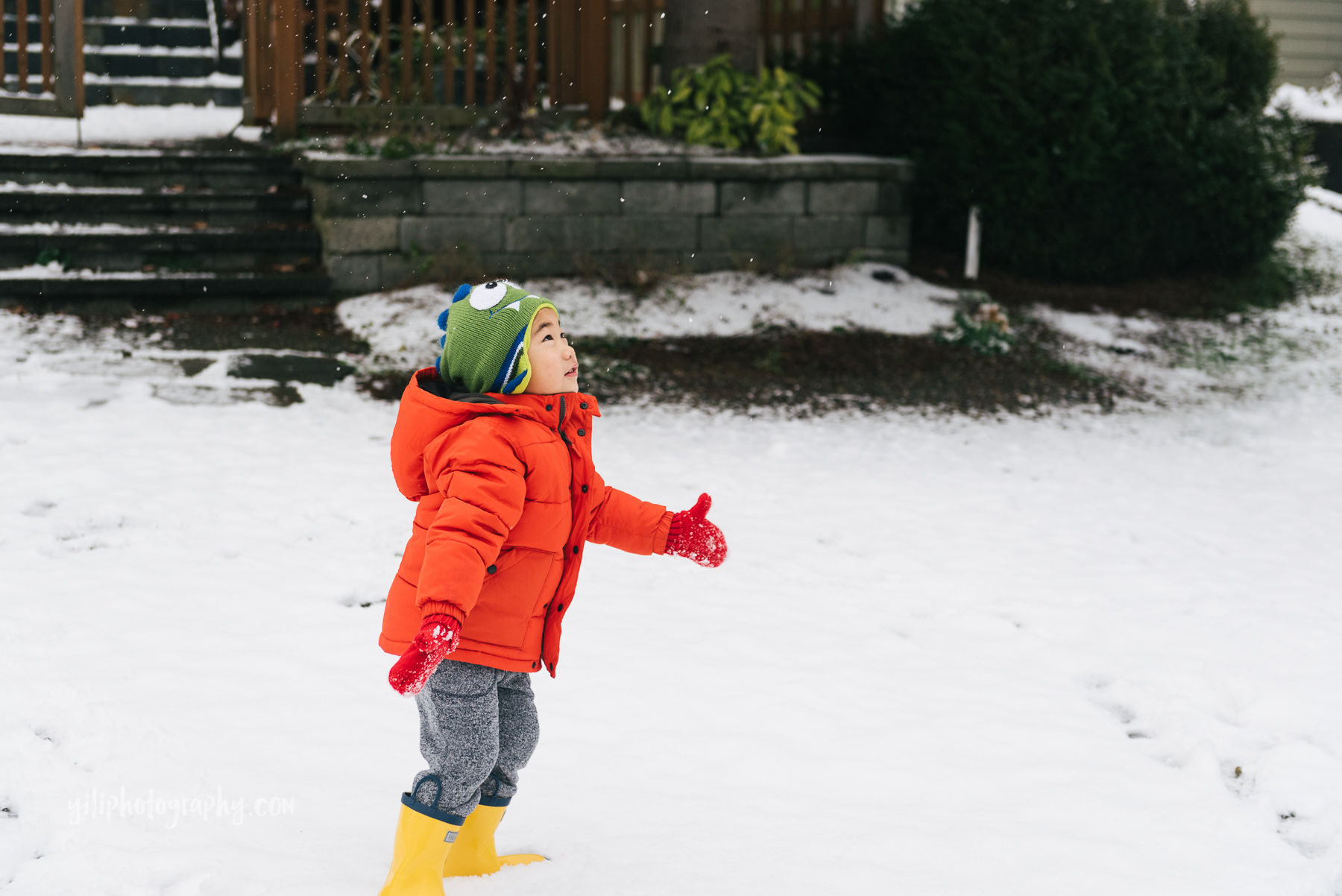 little boy throwing snow in seattle