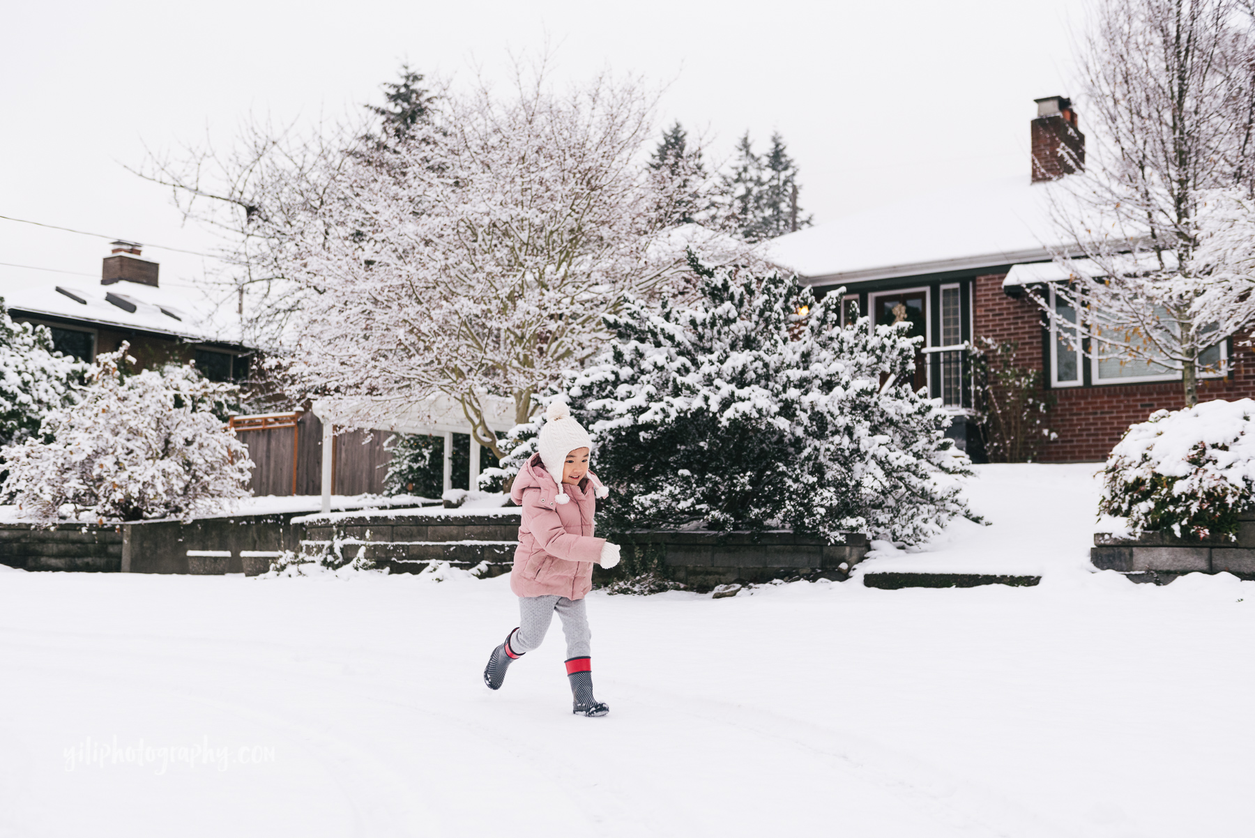 little girl running in snow seattle