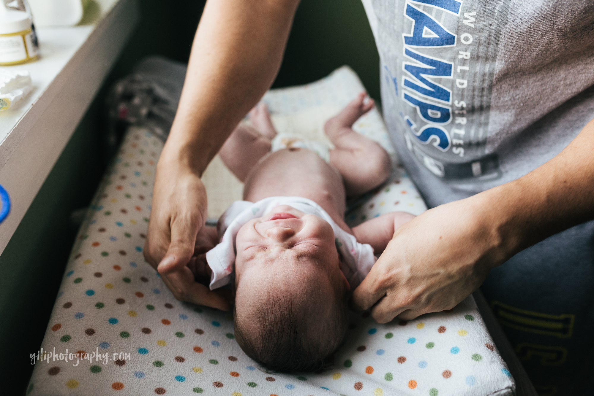 seattle father changing baby girls clothes