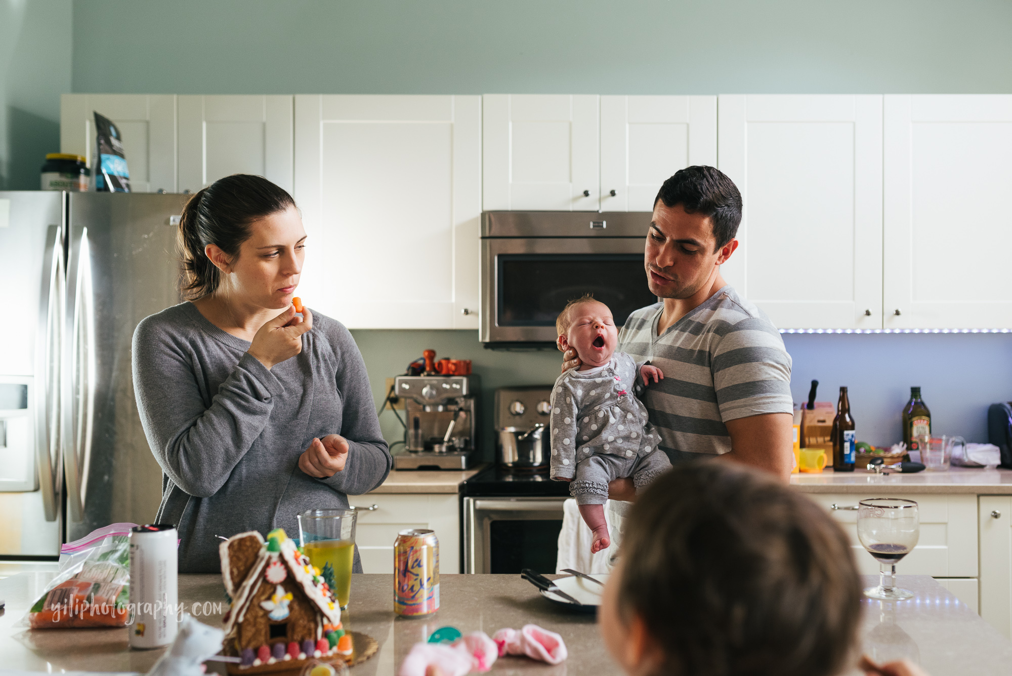 seattle family eating together in kitchen with newborn baby