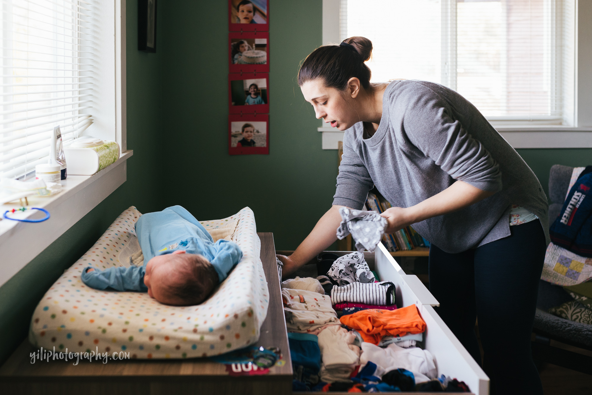 seattle newborn with mom organizing clothes drawer