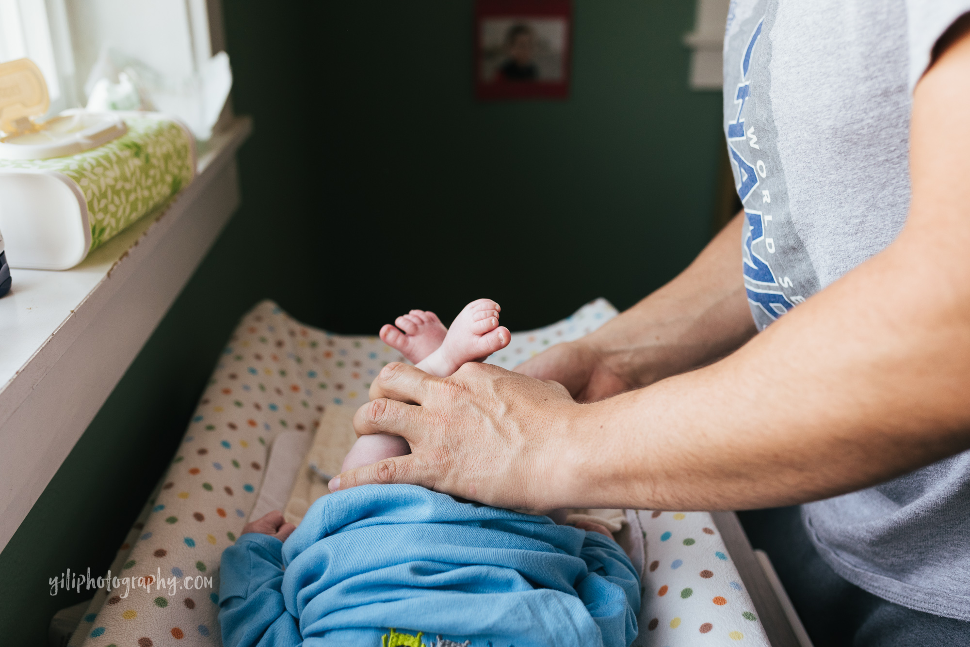 seattle father changing newborn baby diaper