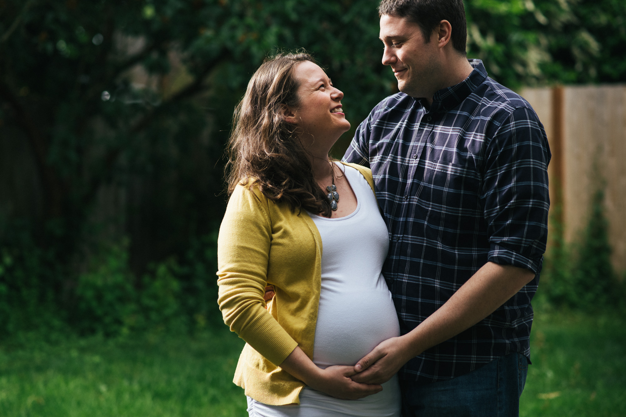 maternity couple looking at each other