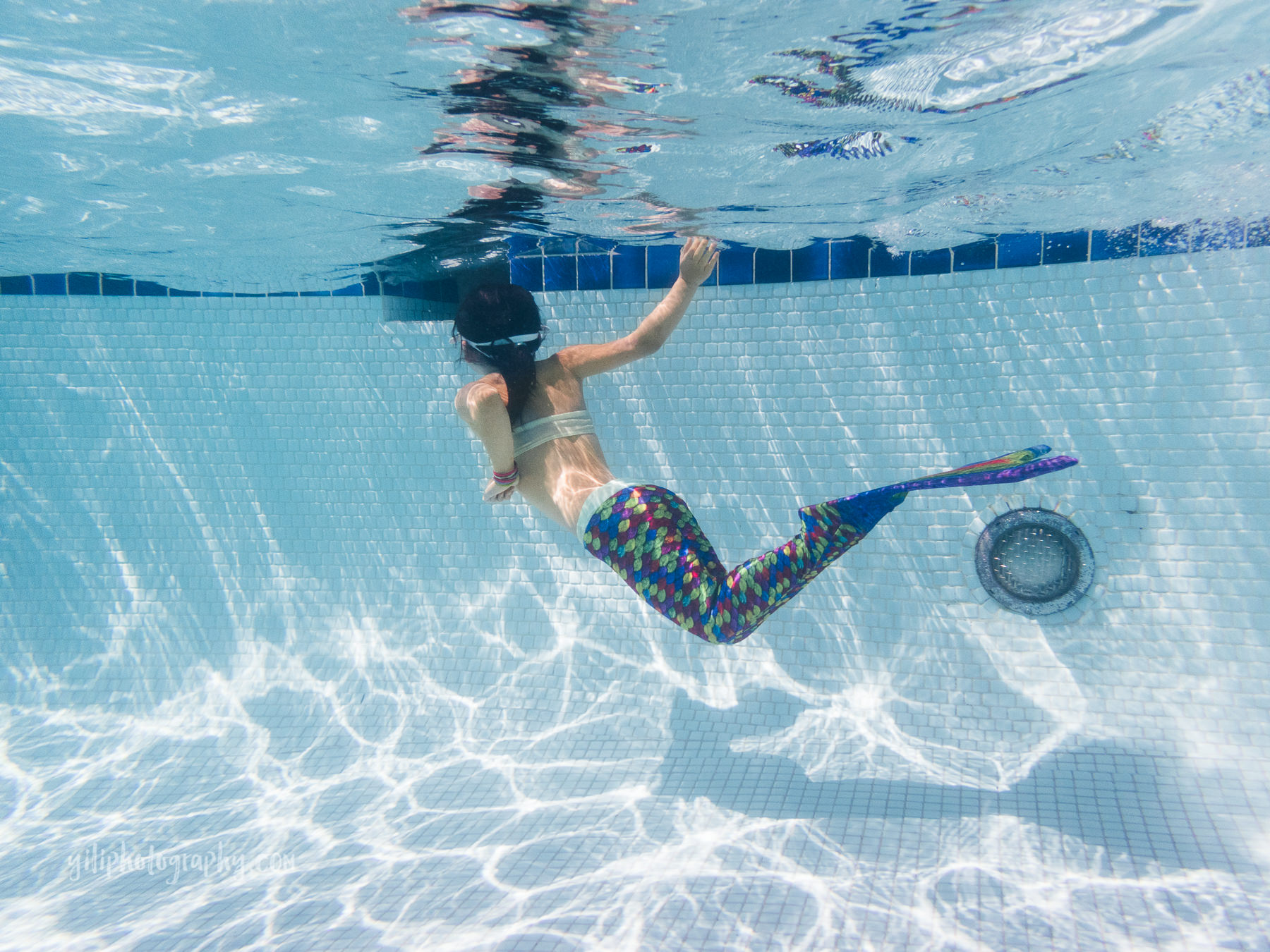 girl swimming with mermaid tail