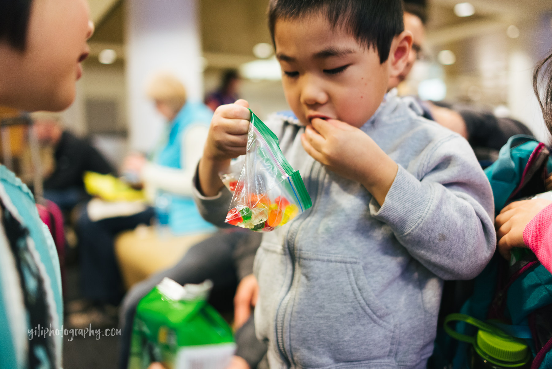 little boy looking in bag of gummy bears