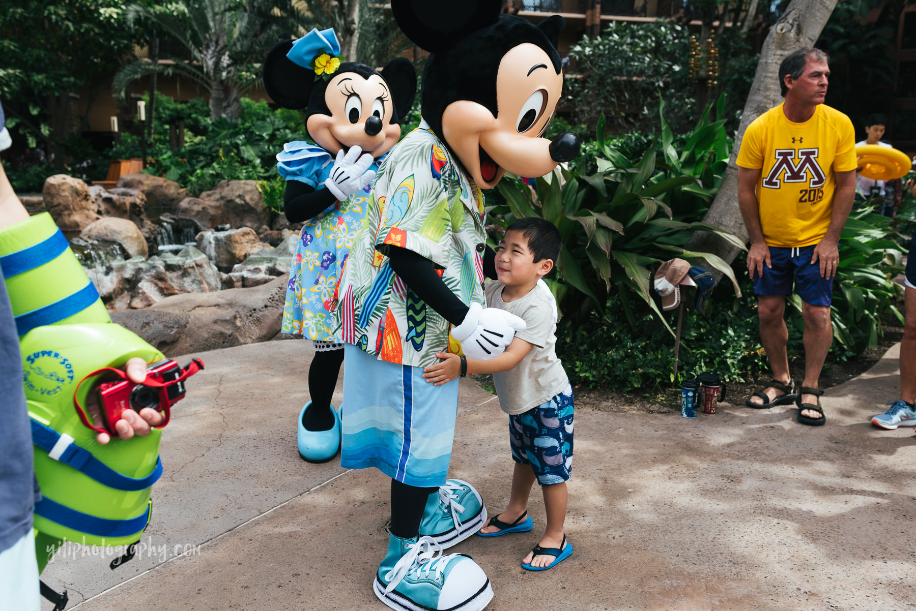 little boy gives mickey a hug at aulani