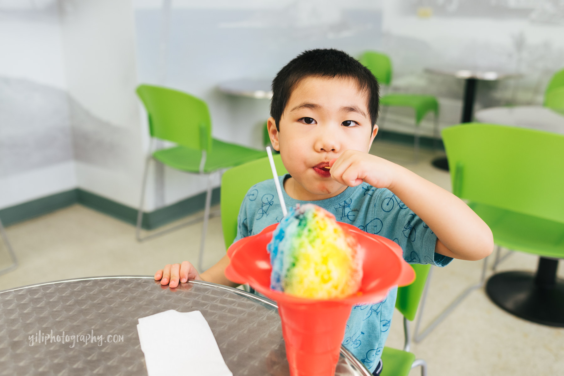 boy eating rainbow shave ice