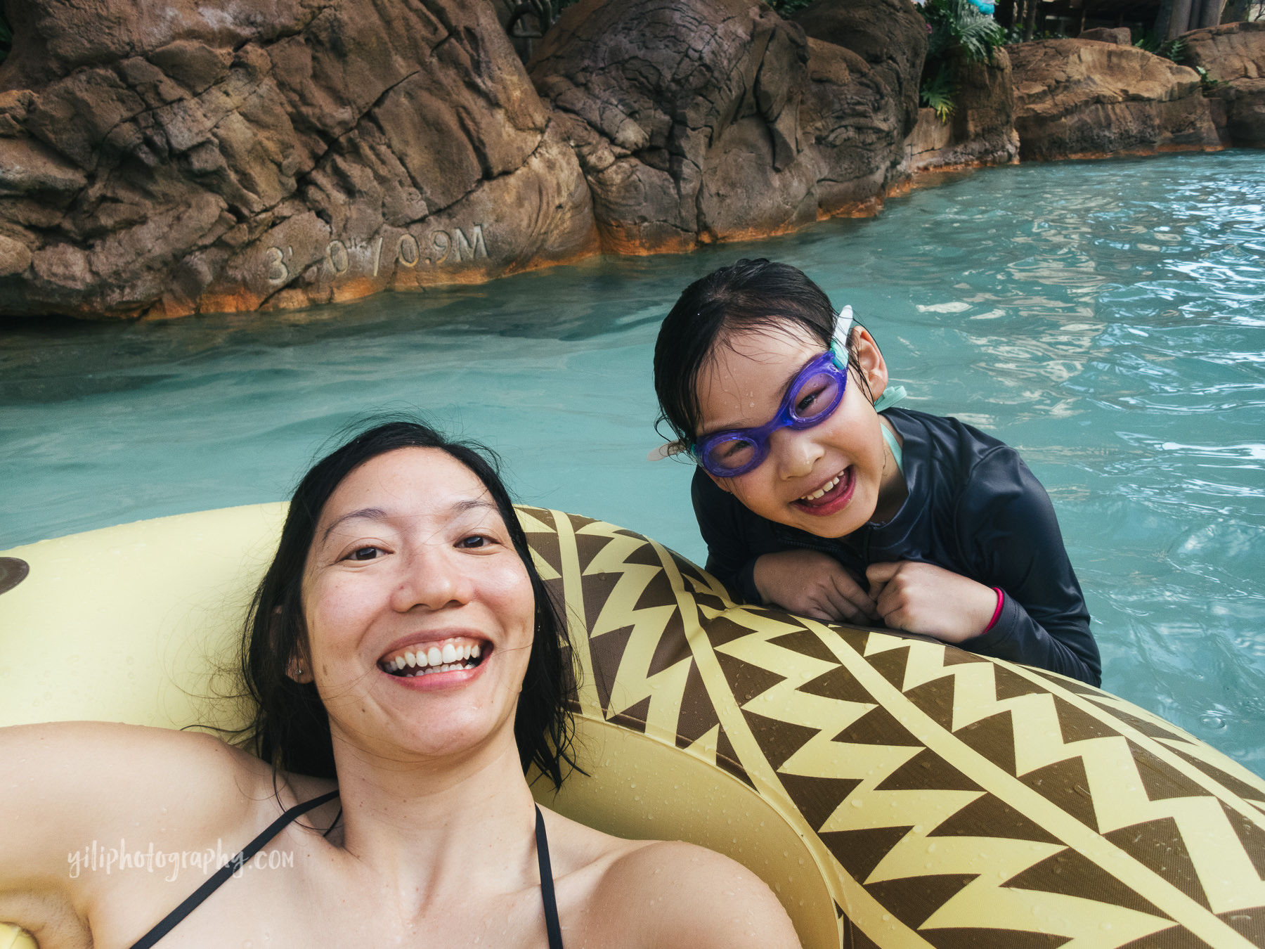 mom in inner tube with daughter in lazy river