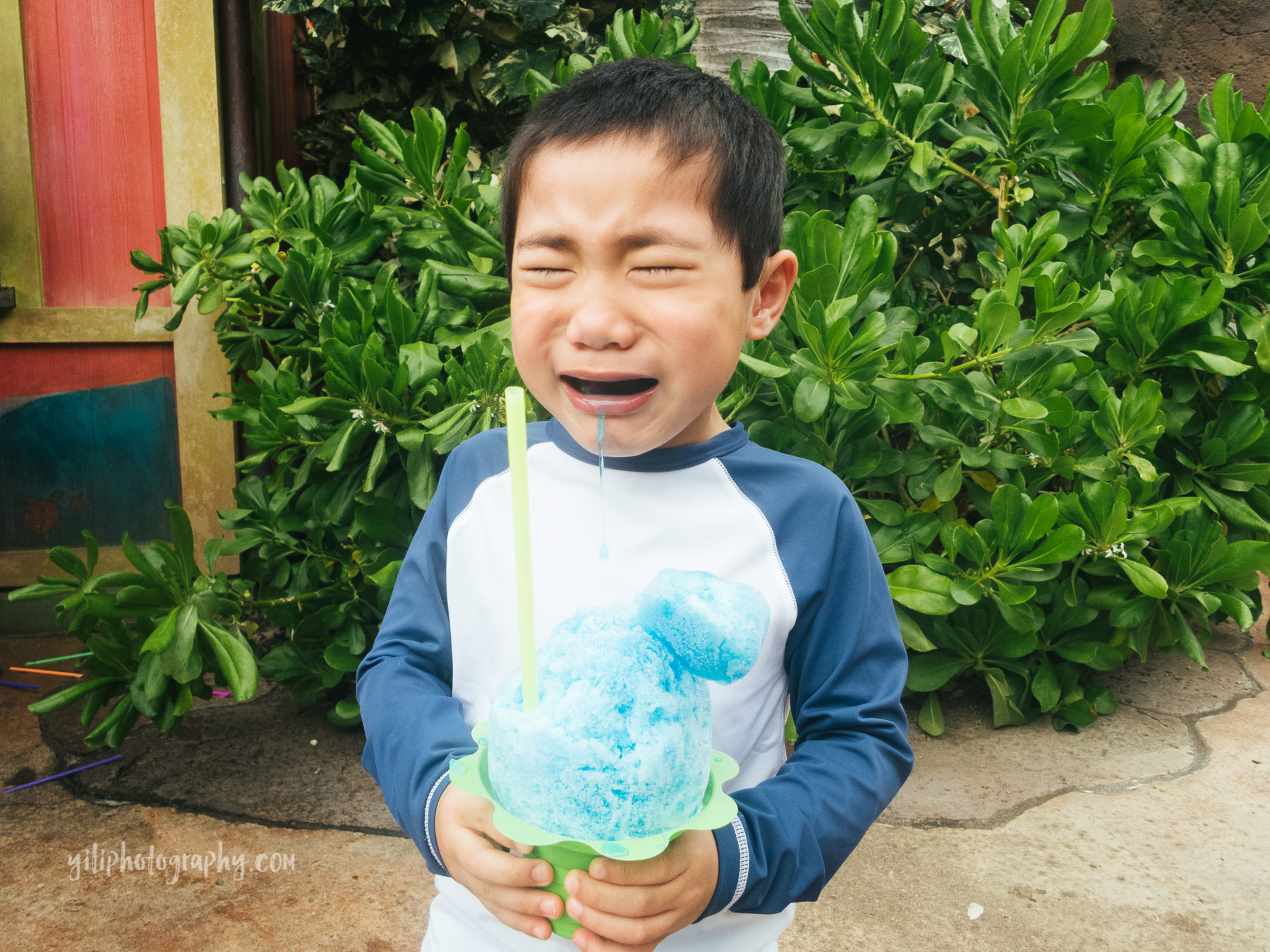 boy holding shave ice crying