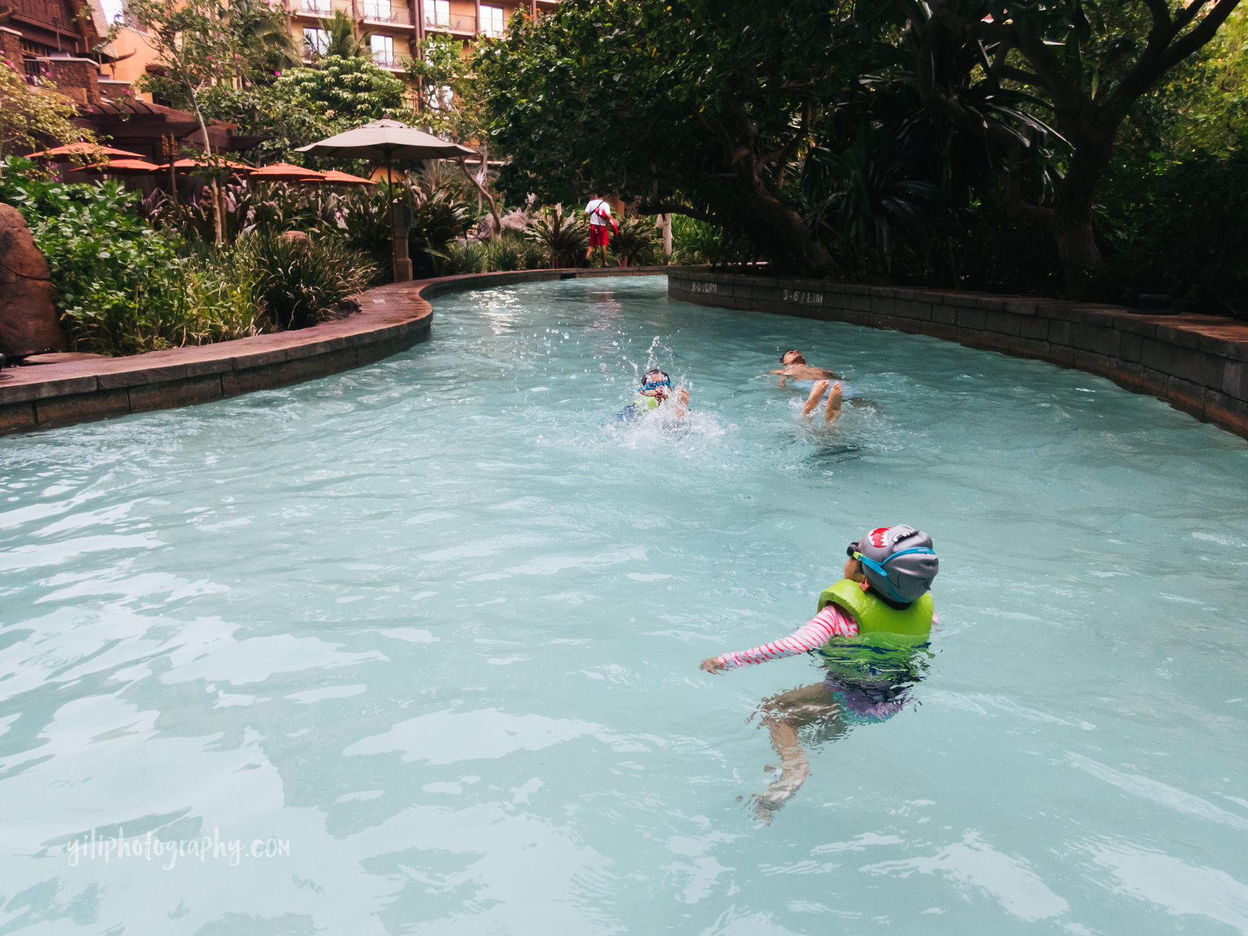 family floating down lazy river at Aulani