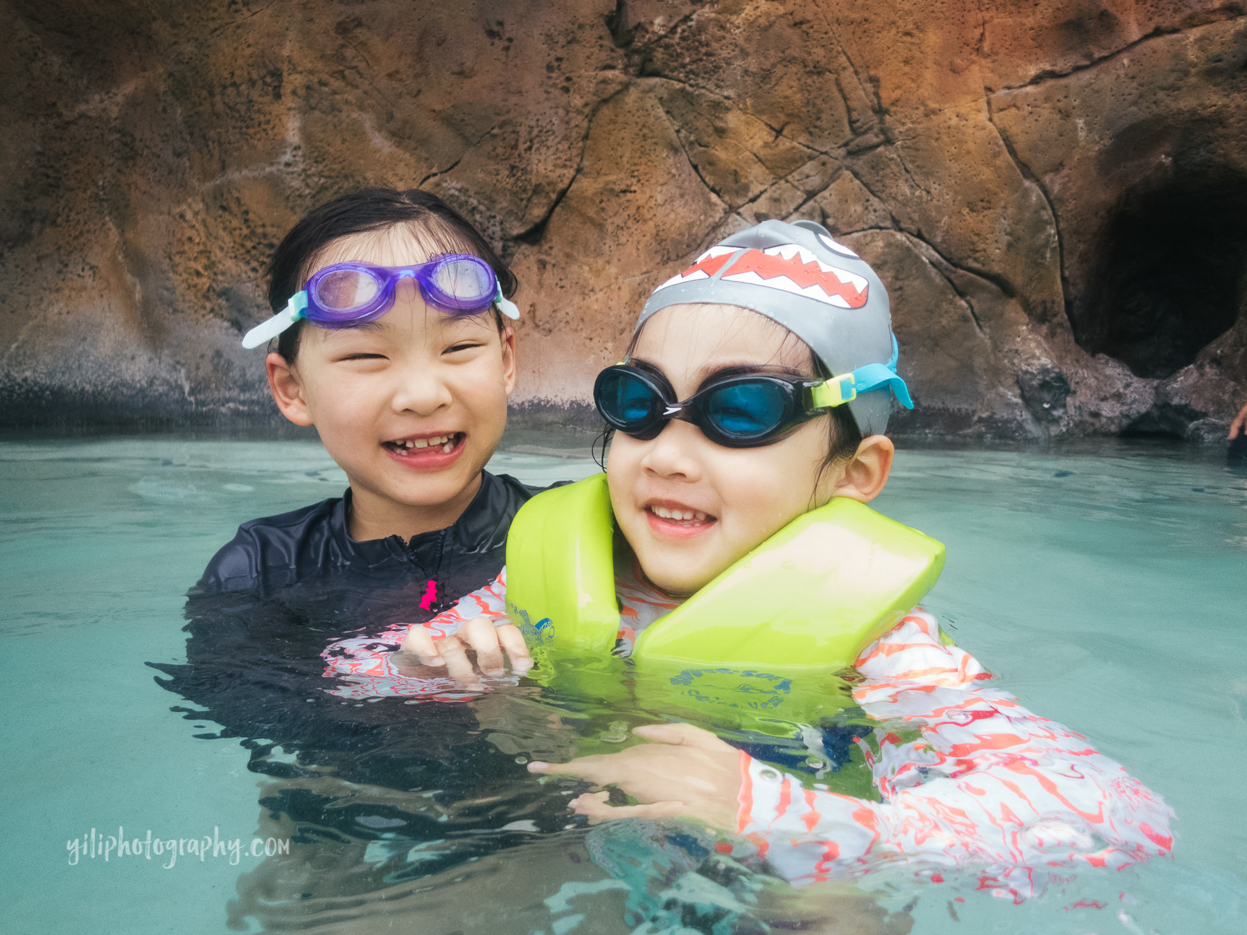 sisters wearing goggles in pool together