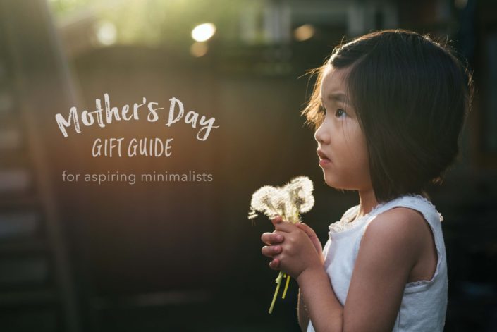 little girl holding bouquet of dandelions