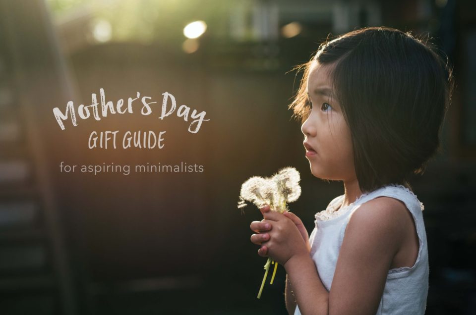 little girl holding bouquet of dandelions