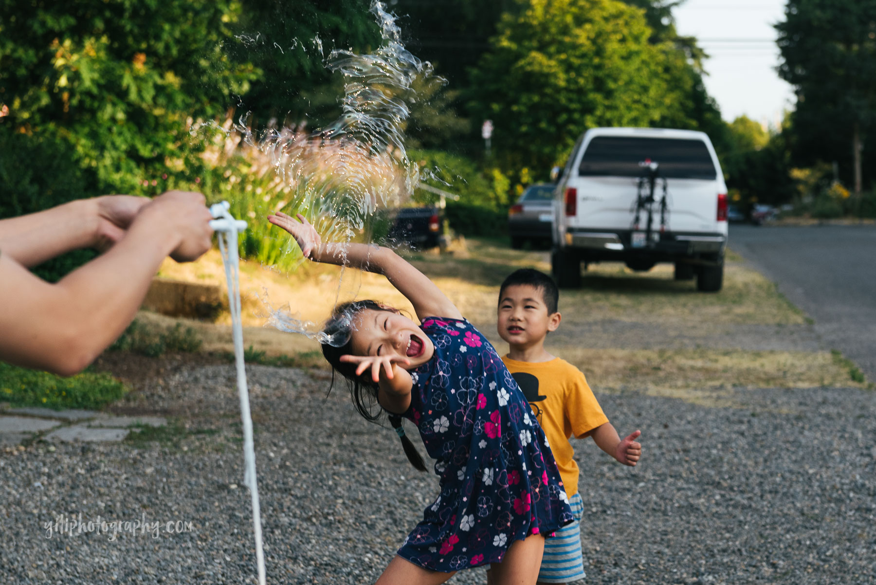 girl popping giant bubble with her hands