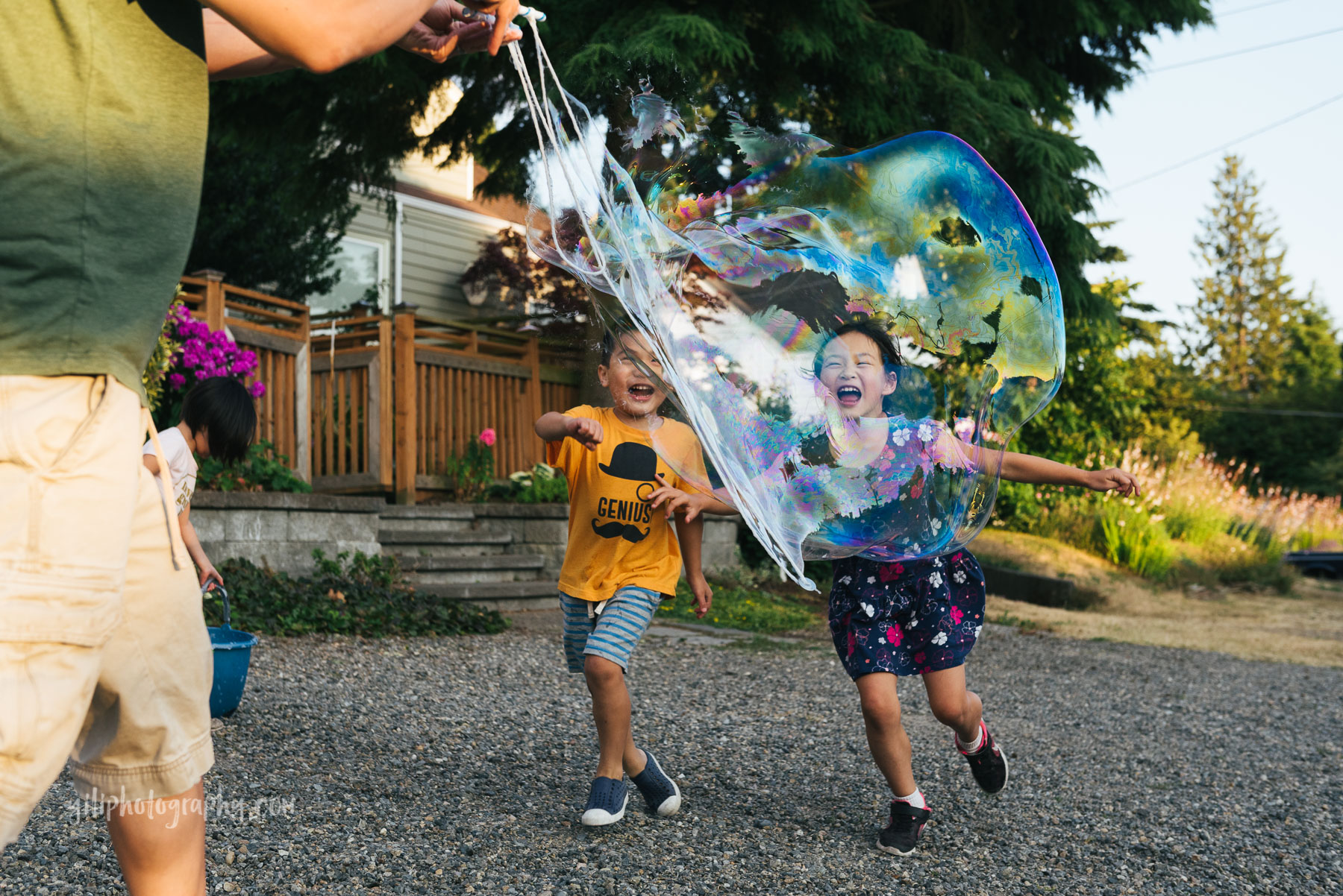 boy and girl running towards giant bubble