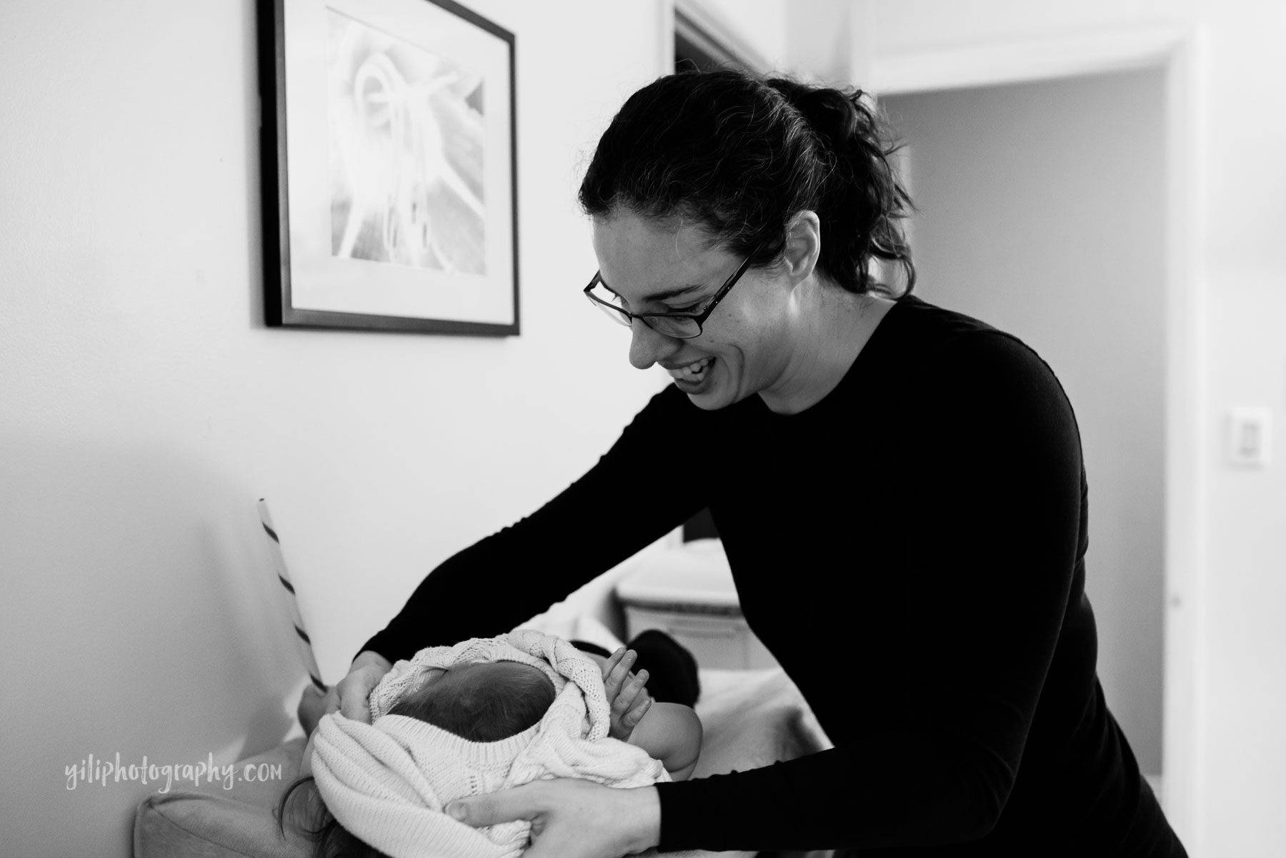 Mother getting her toddler girl dressed on changing table