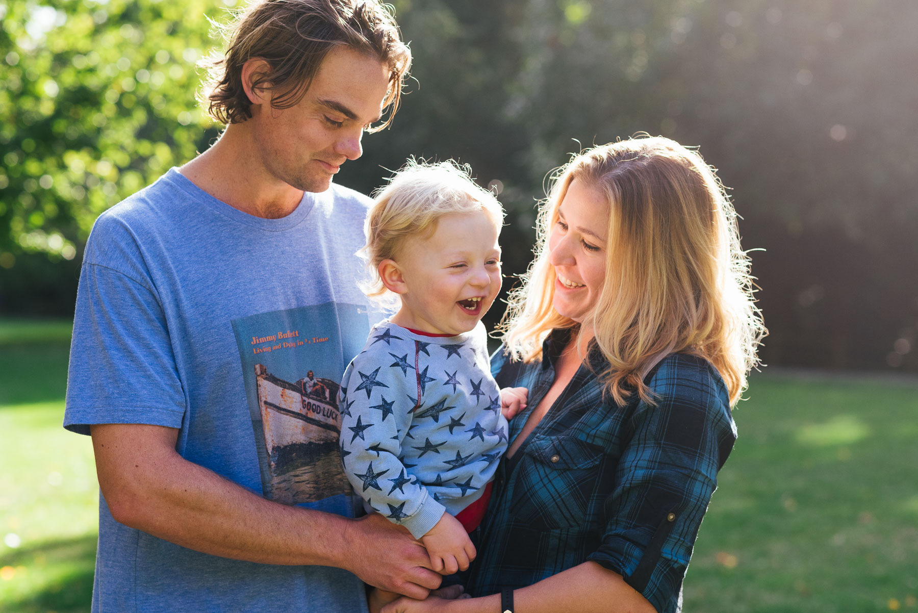 Caucasian family posing for backlit portrait at Carkeek Park Seattle