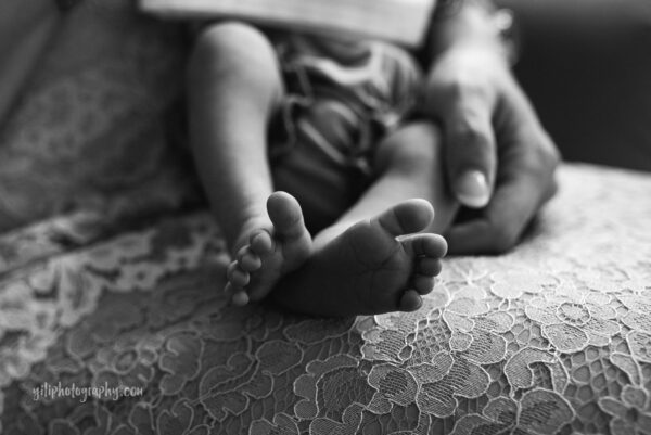 black and white close up of newborn baby toes