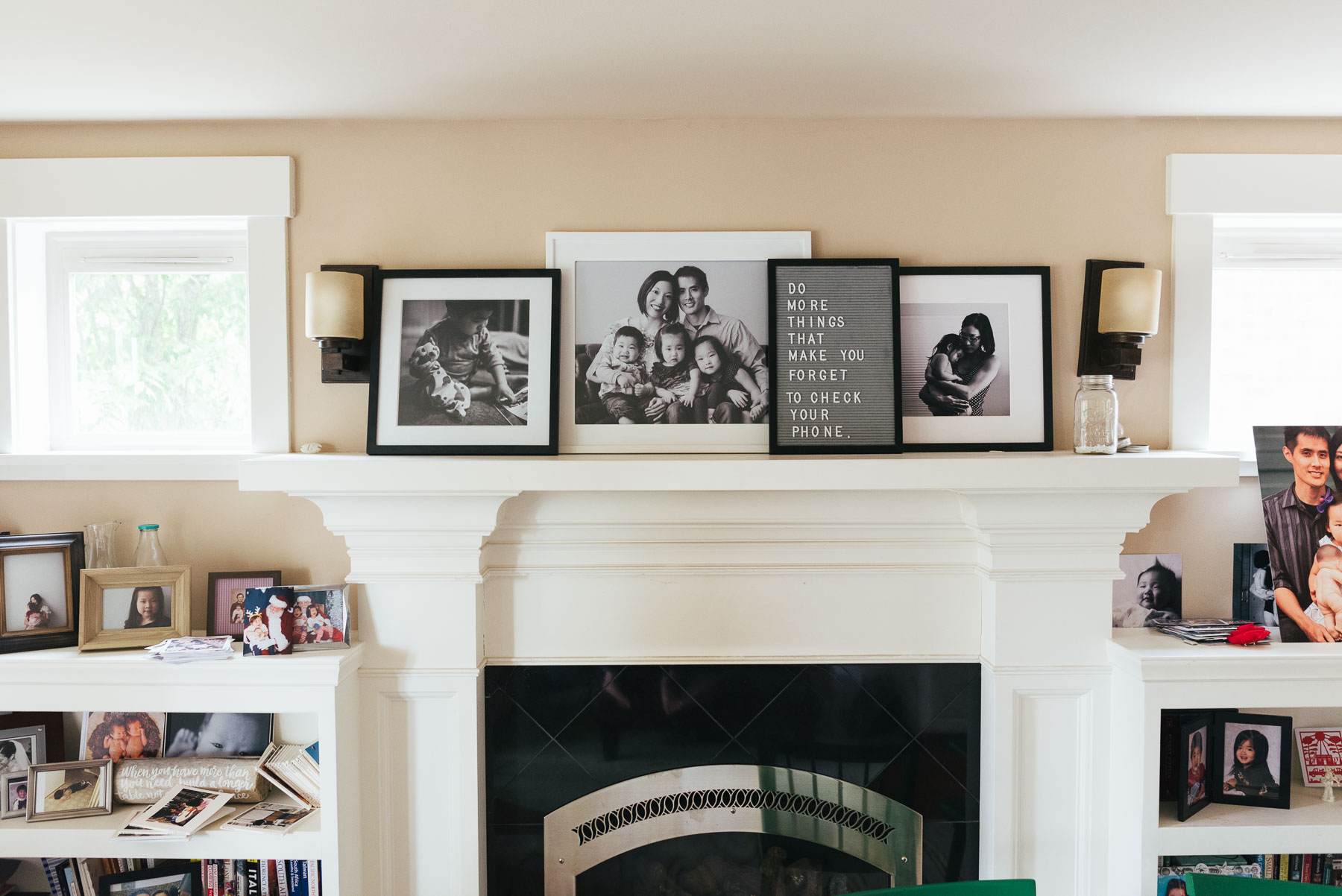 large framed photographs above fireplace mantle in home