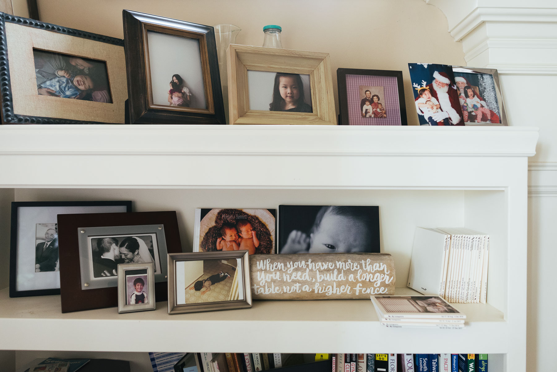 built-in bookshelf with framed photographs and photo books