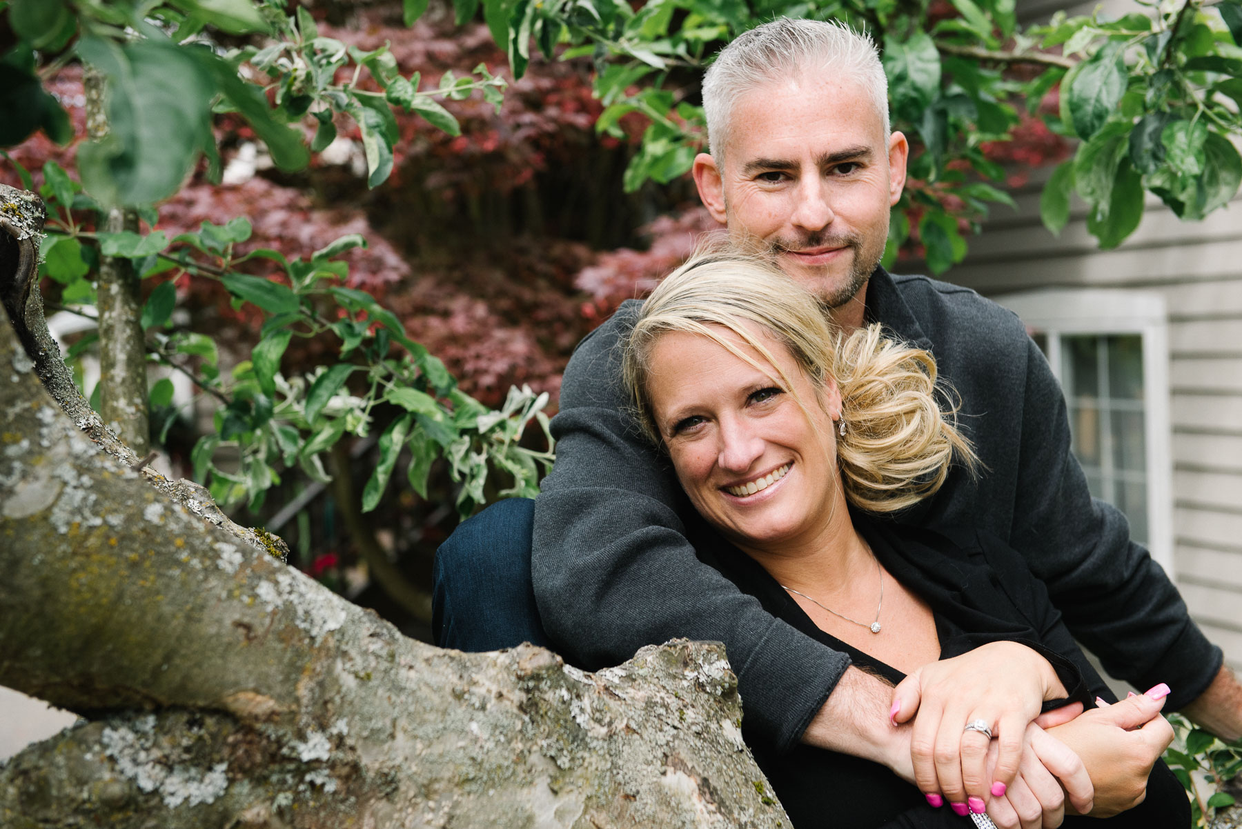 mother and father together in front yard apple tree