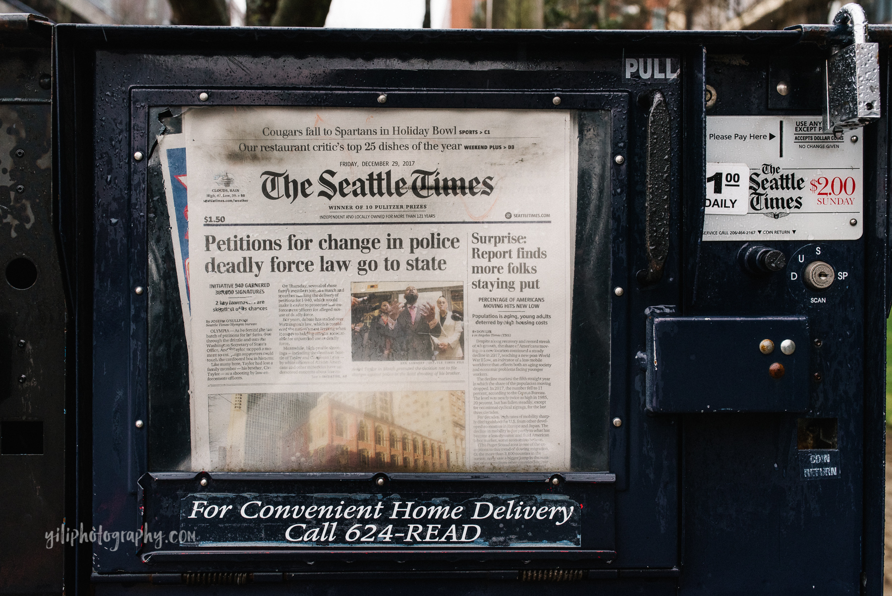 newspaper vending machine showing seattle headline