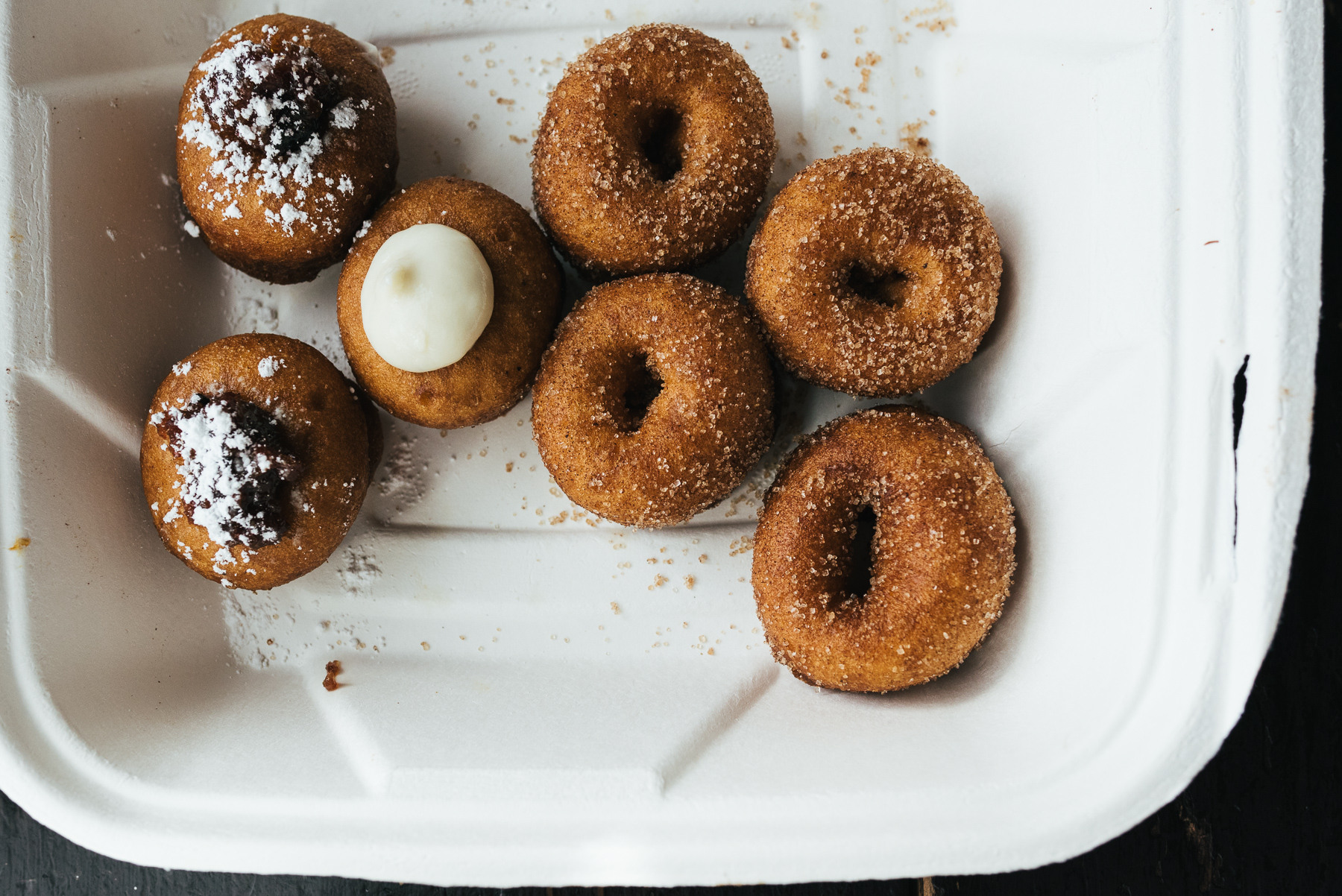 mini doughnuts in a take out box