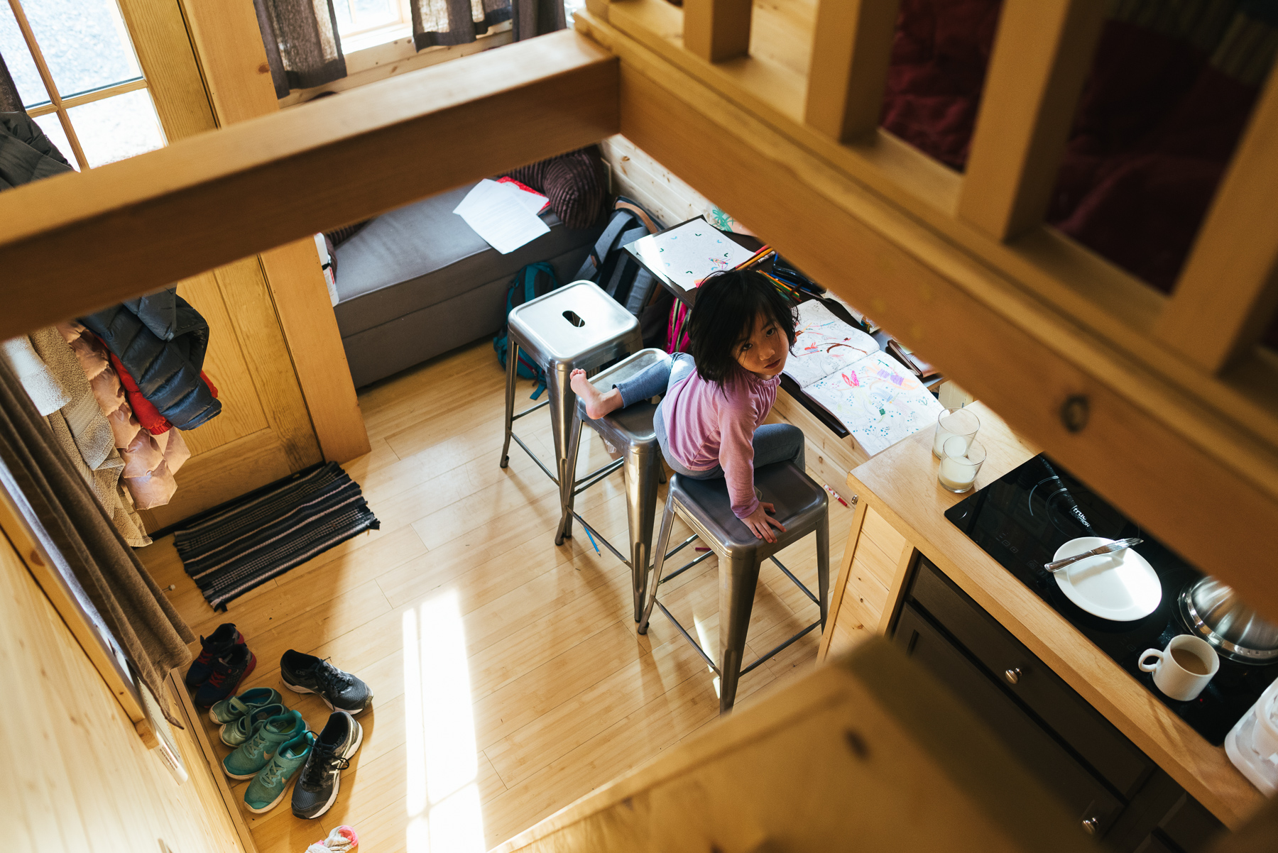 photo from loft of little girl in downstairs of tiny home