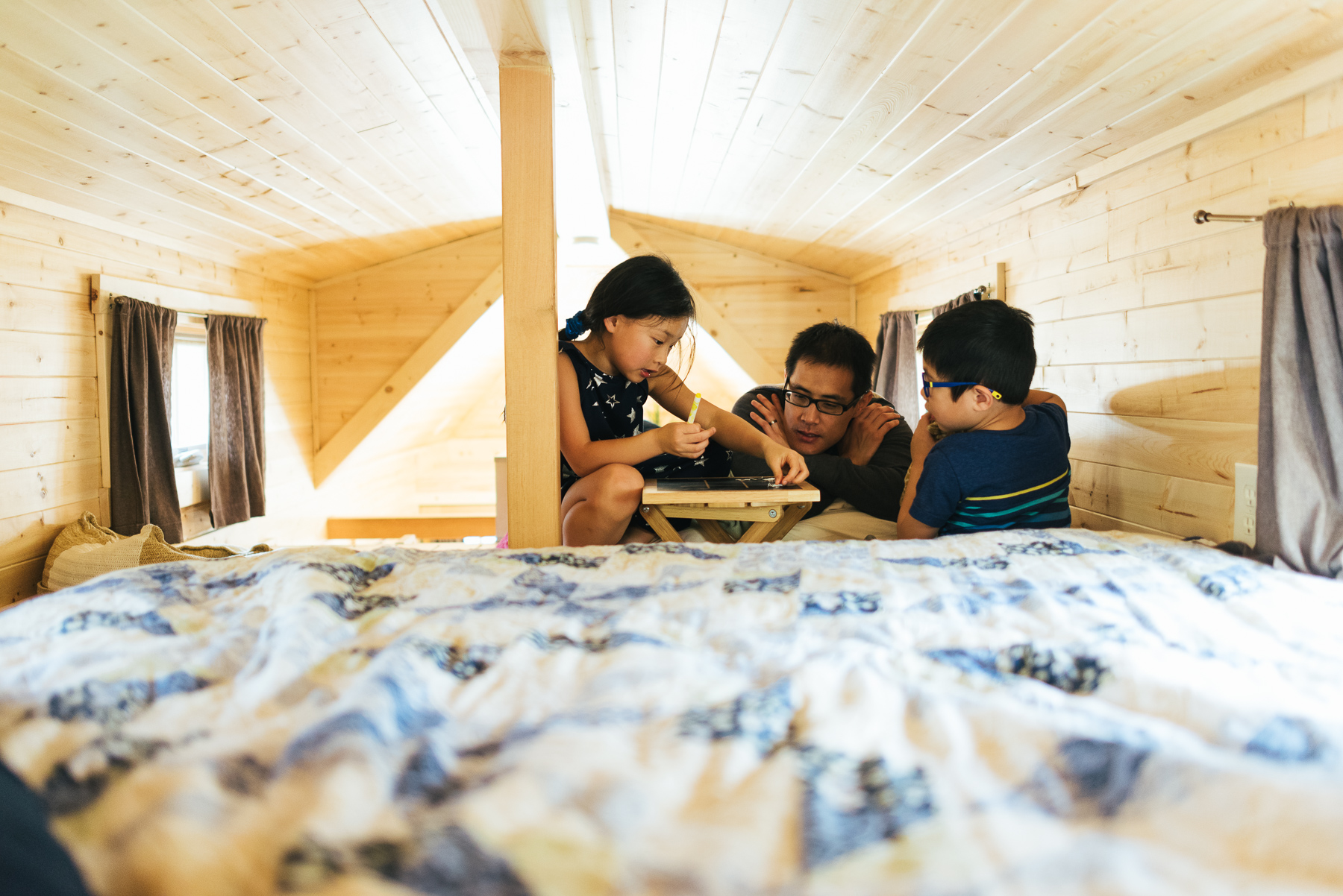 father with two kids in tiny house loft