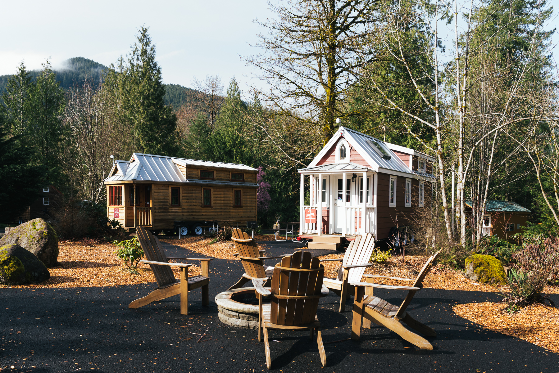 two tiny houses and firepit outdoors