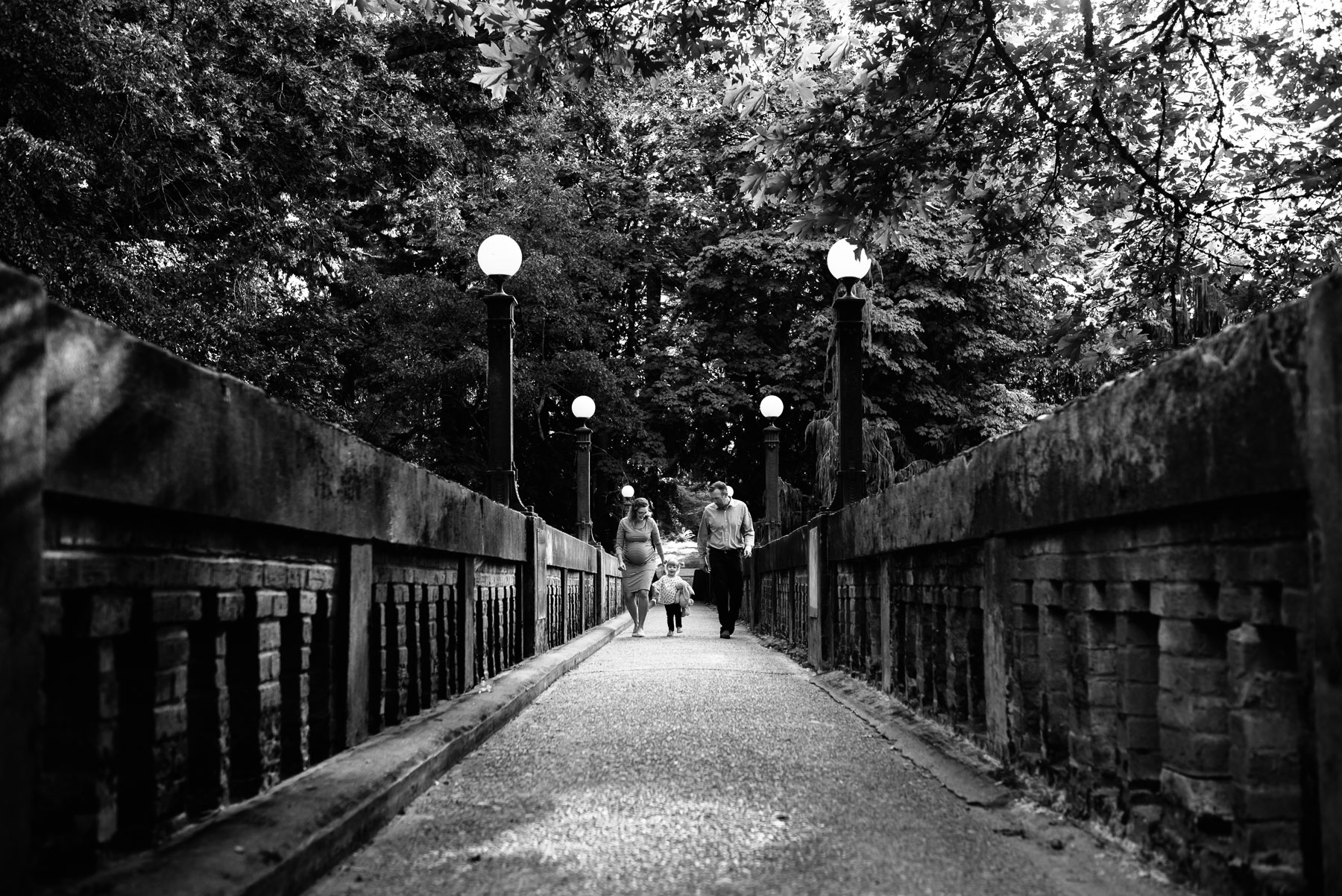 family walking across footbridge in seattle arboretum