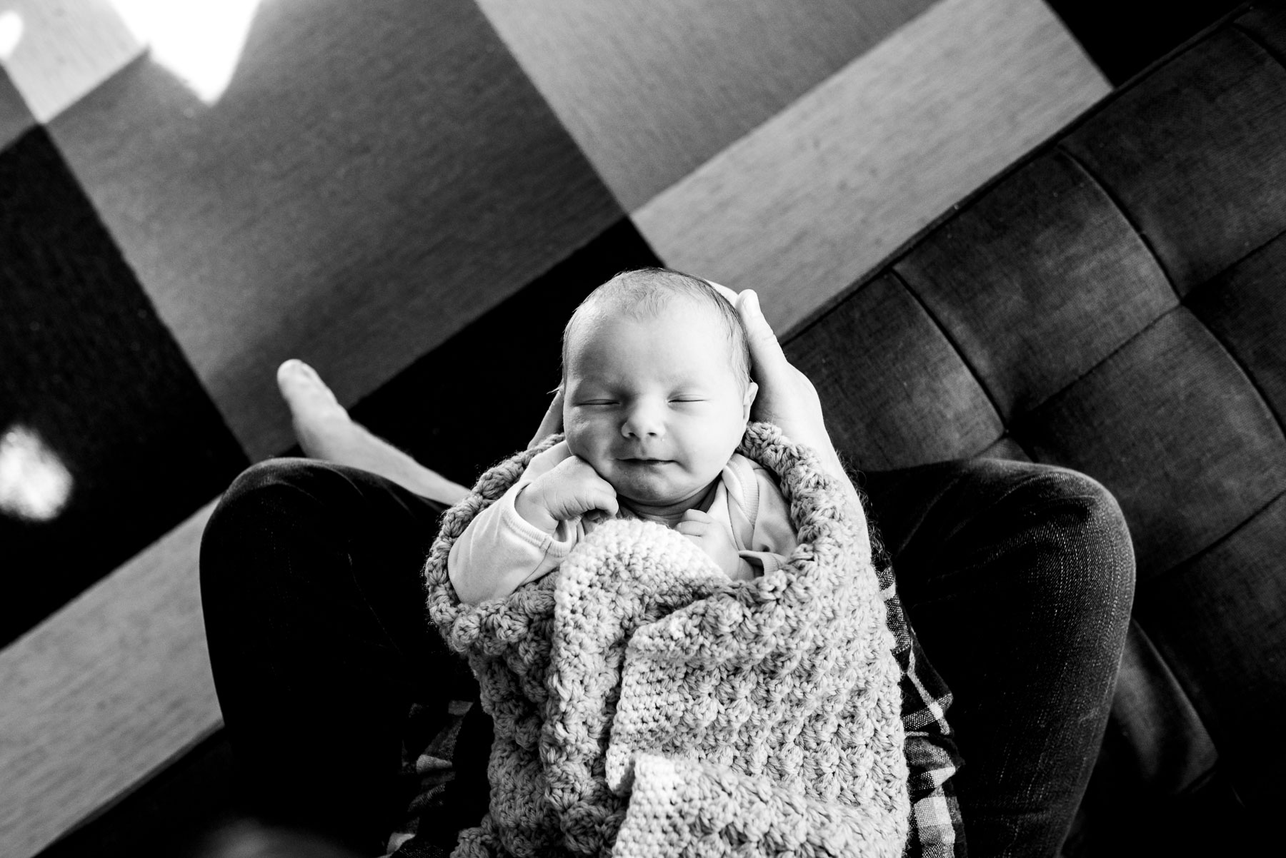 top down photo of dad holding newborn baby girl