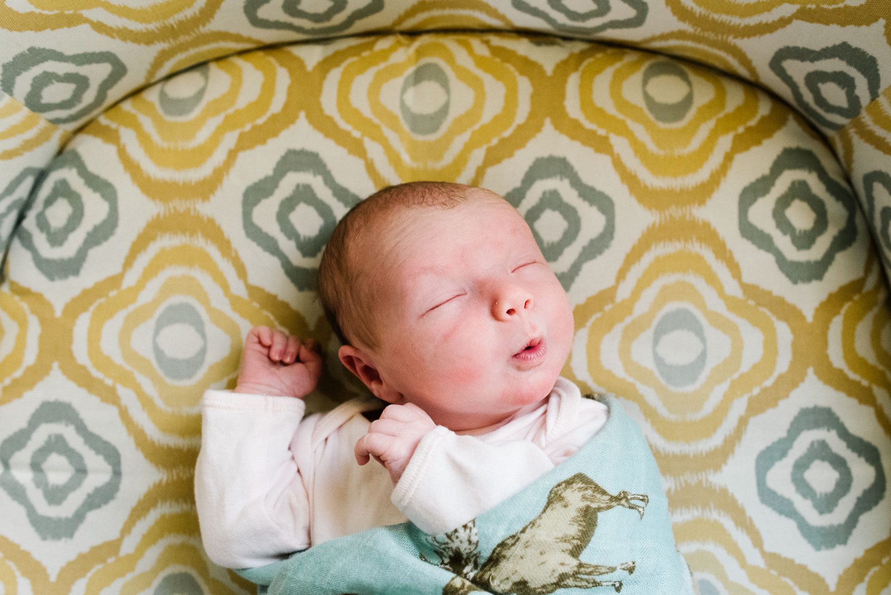 newborn baby girl making funny face