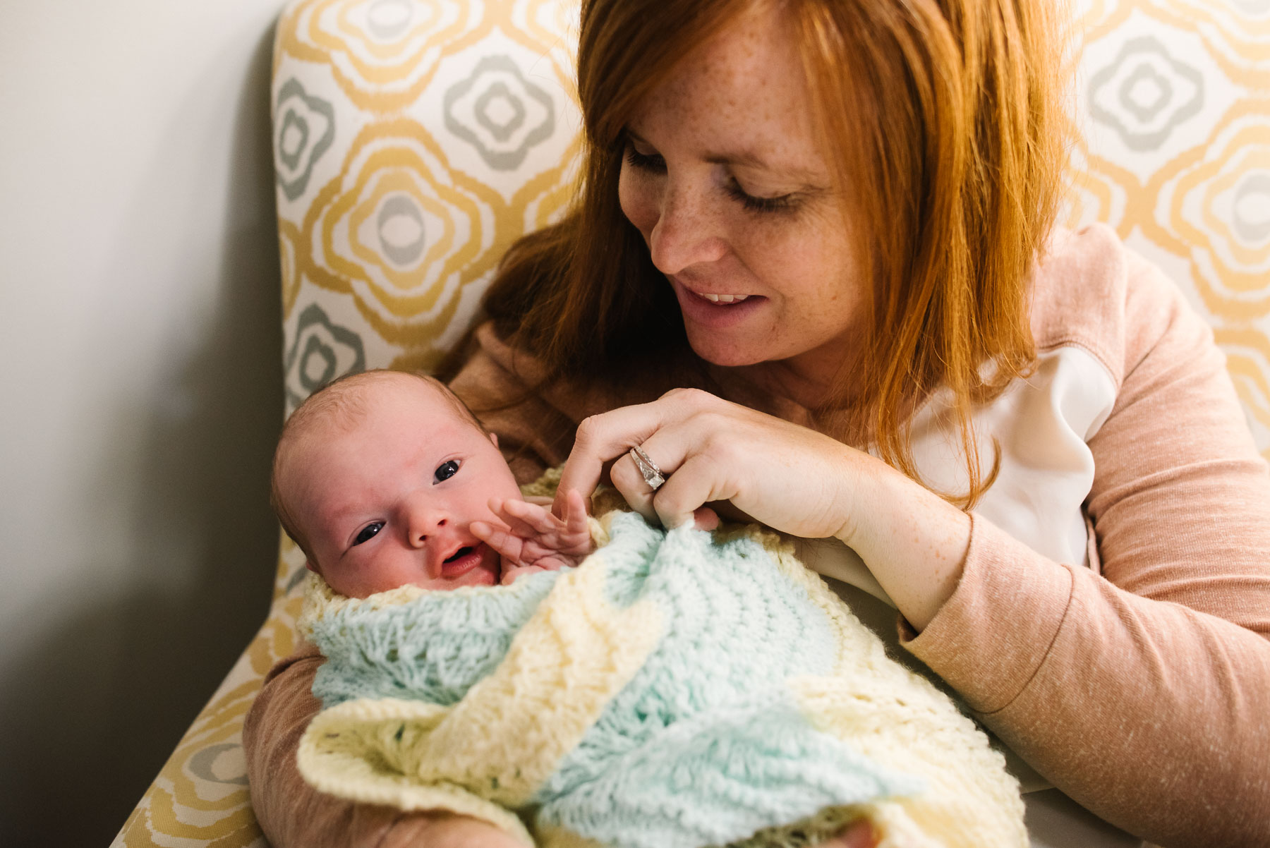 mom interacting with awake newborn baby girl