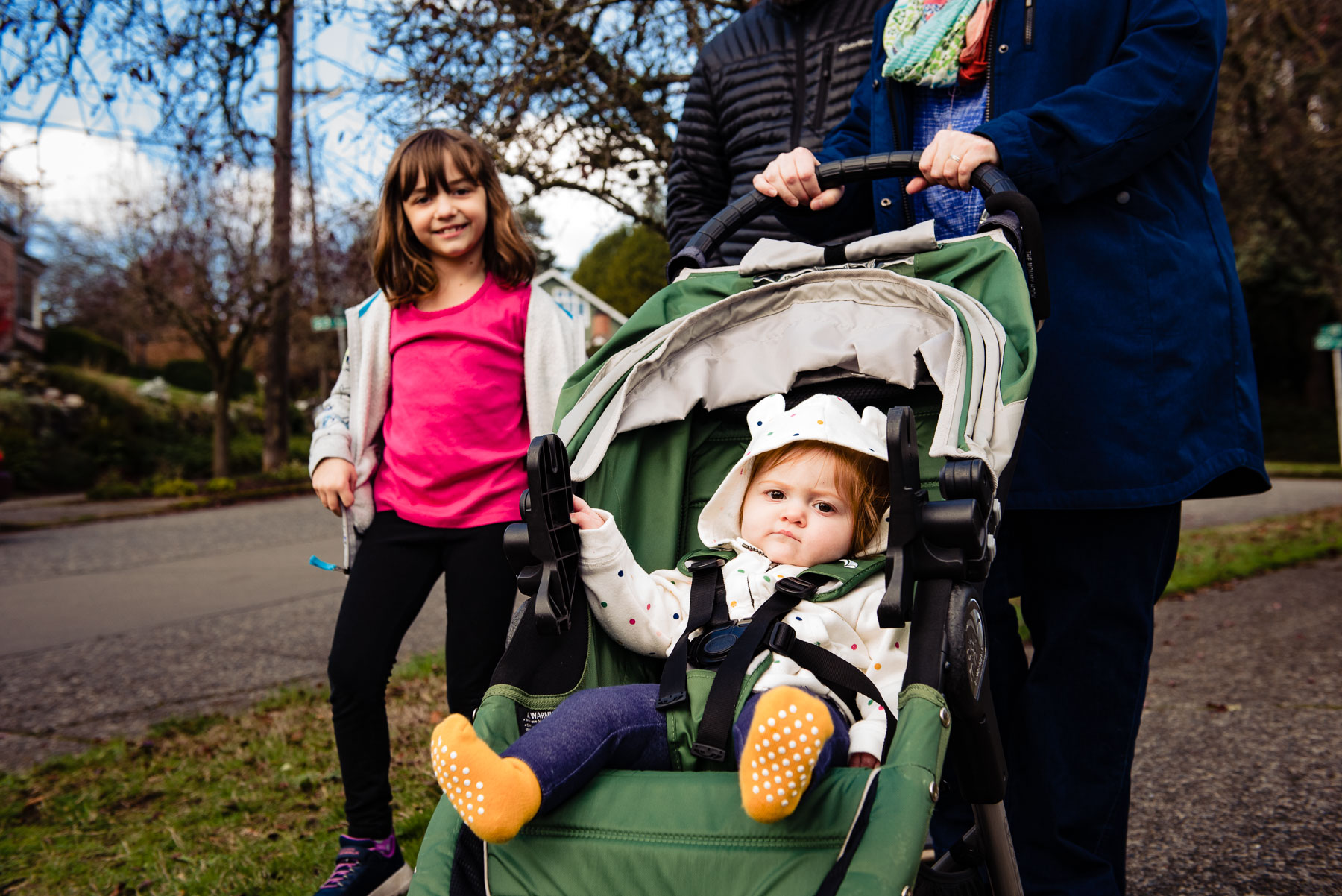 baby in stroller with sister walking