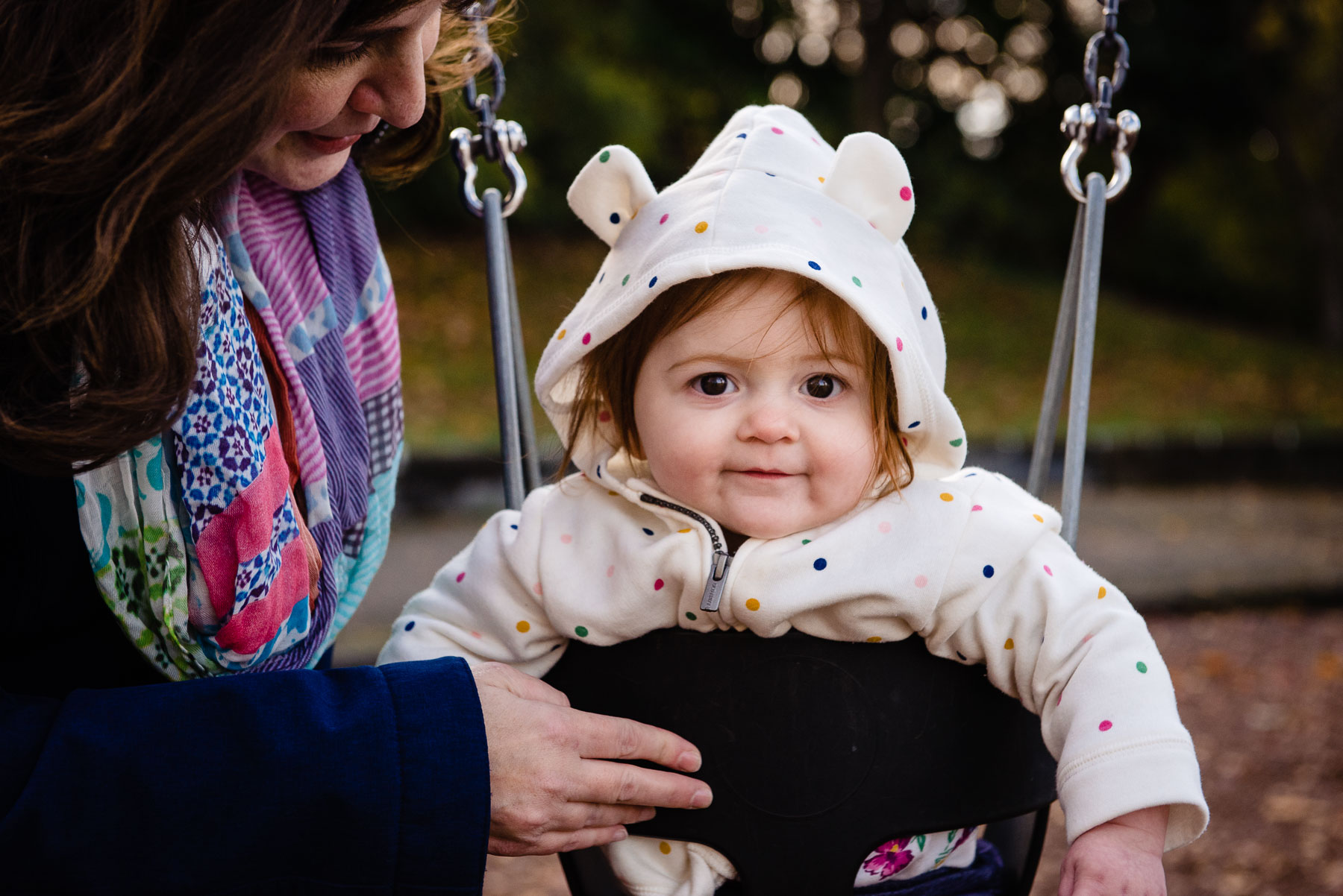 baby with hoodie on swing