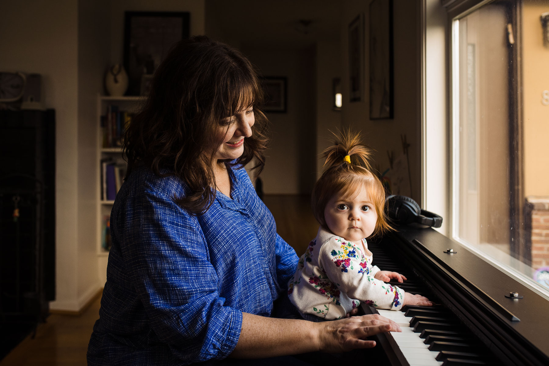 mother sitting at piano with baby