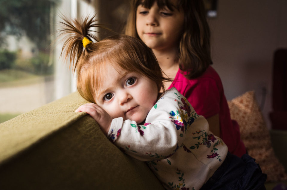 sister and baby together on couch