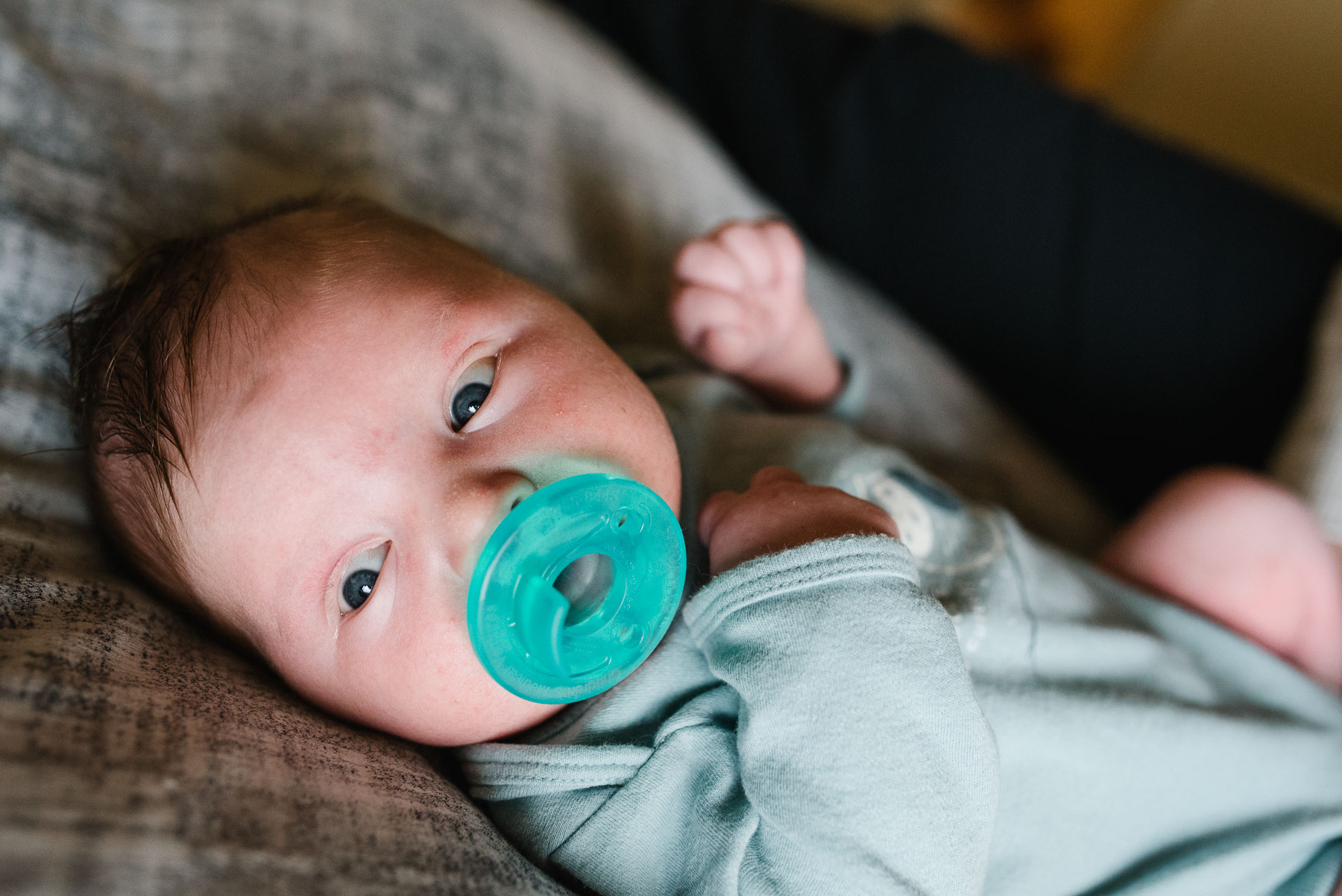 baby boy with aqua pacifier