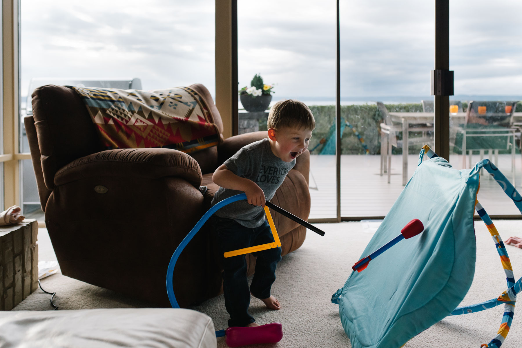 toddler boy playing with toys at home