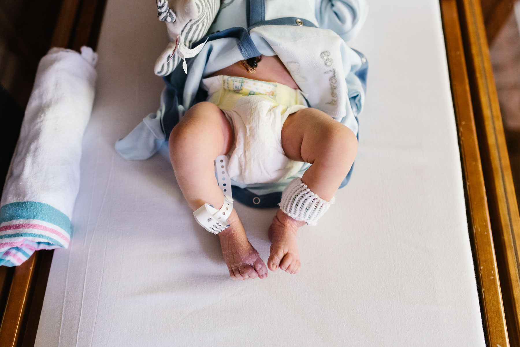 close up of newborn baby legs and feet