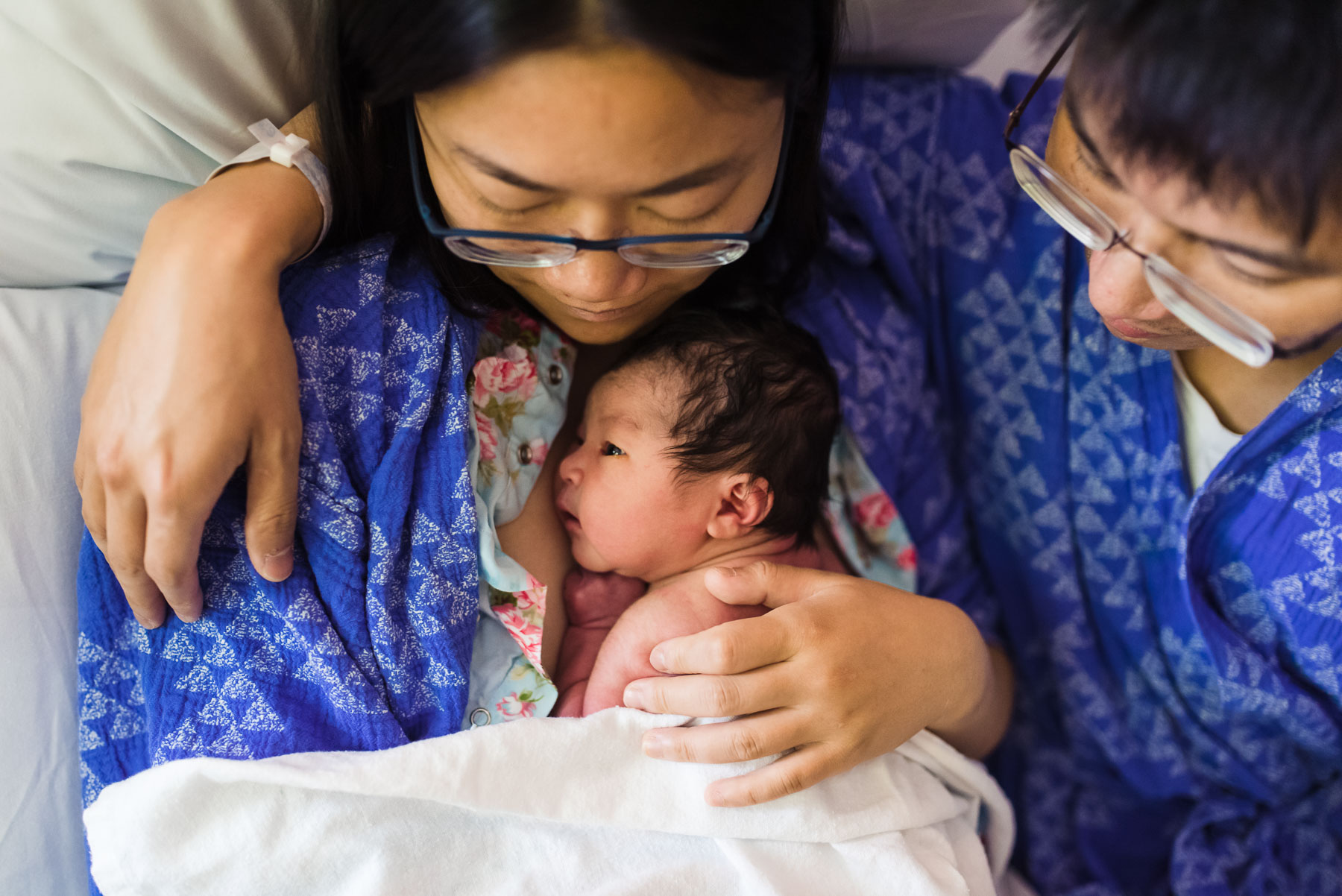 newborn baby girl doing skin to skin with mother in hospital