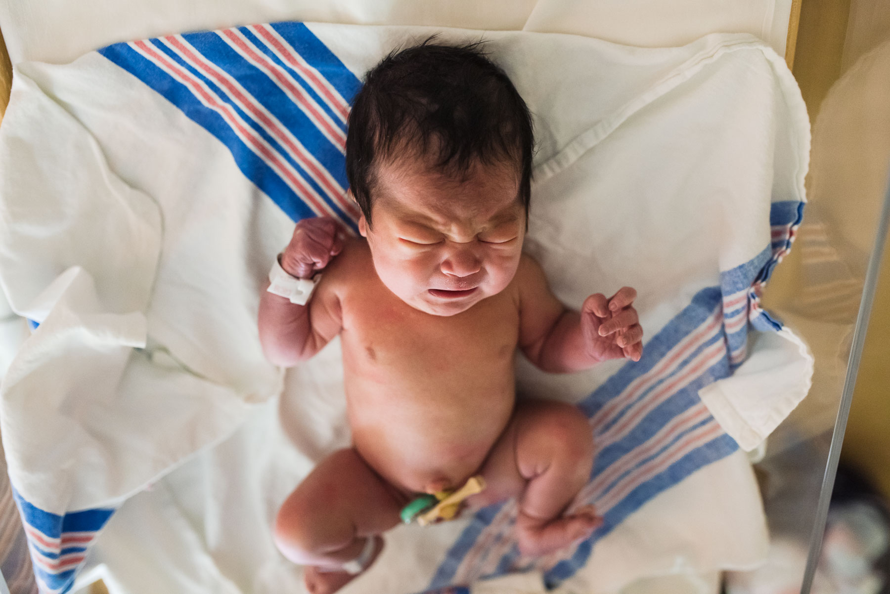 newborn baby girl crying in hospital