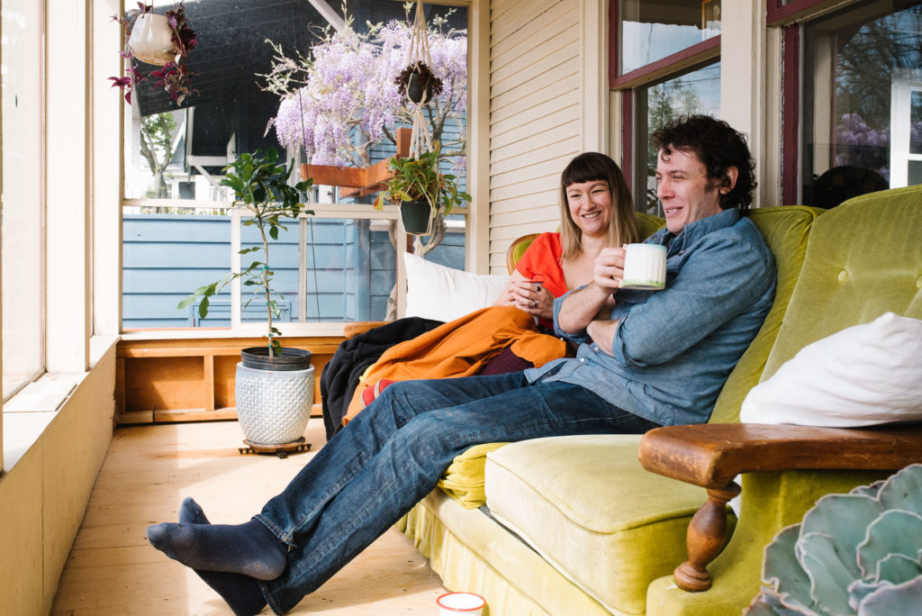 husband and wife relaxing on front porch