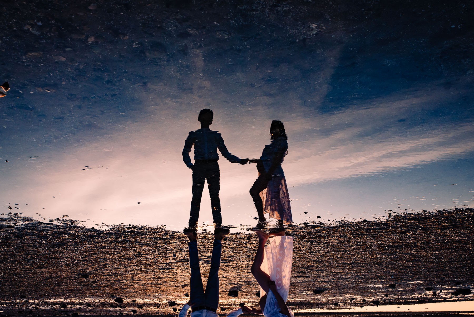 reflection of pregnant couple in water