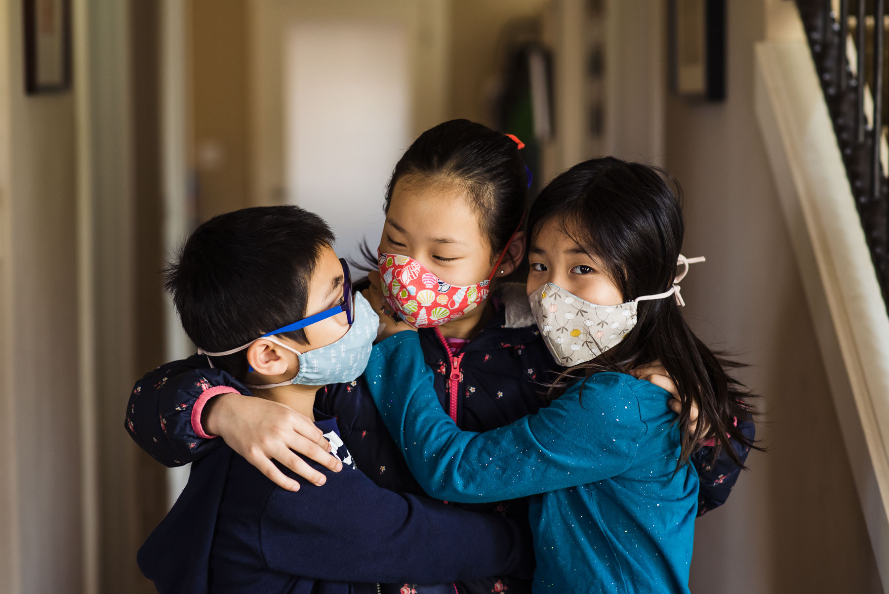 Asian siblings wearing cloth face masks