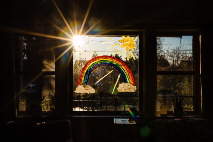 rainbow painted on window inside home