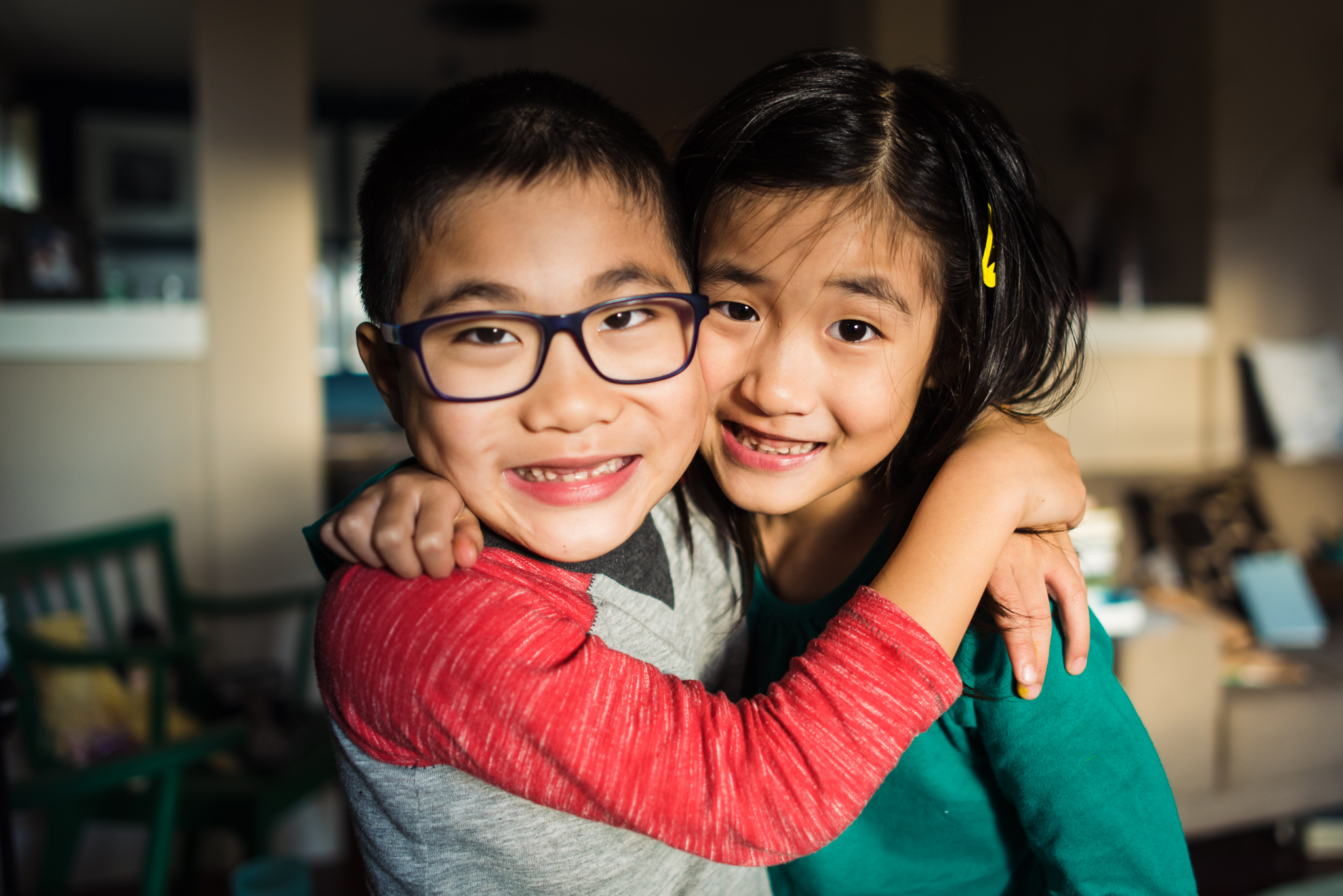 boy girl twins cuddling at home