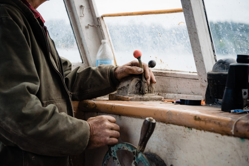 detail of lobster fisherman driving boat